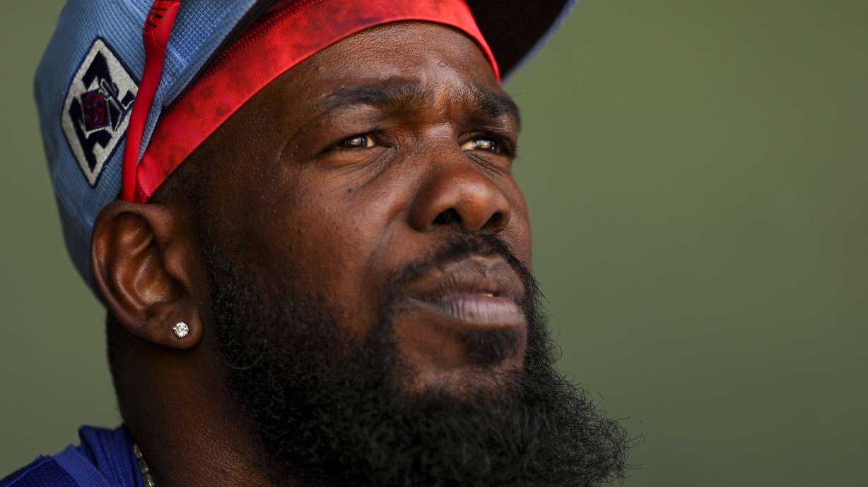 Texas Rangers right fielder Adolis García sits in the dugout before a spring training baseball game against the Chicago Cubs, Friday, Feb. 28, 2025, in Surprise, Ariz.