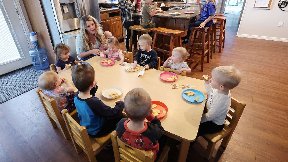 Child care provider Holly Kingston gives children a snack at her home in West Jordan on Jan. 27, 2023. Sen. John Curtis, has signed on to a child care bill as a cosponsor.