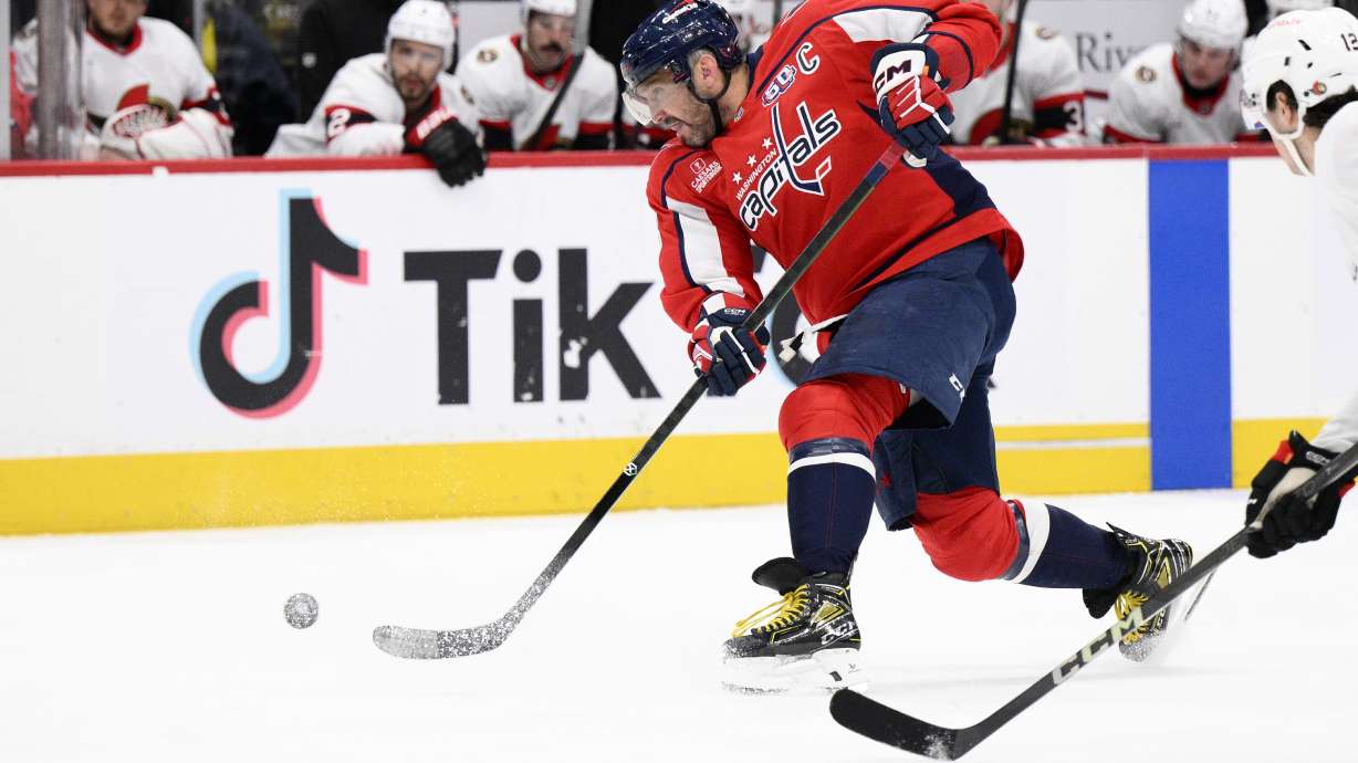 Washington Capitals left wing Alex Ovechkin, left, shoots the puck during the first period of an NHL hockey game against the Ottawa Senators, Monday, March 3, 2025, in Washington.