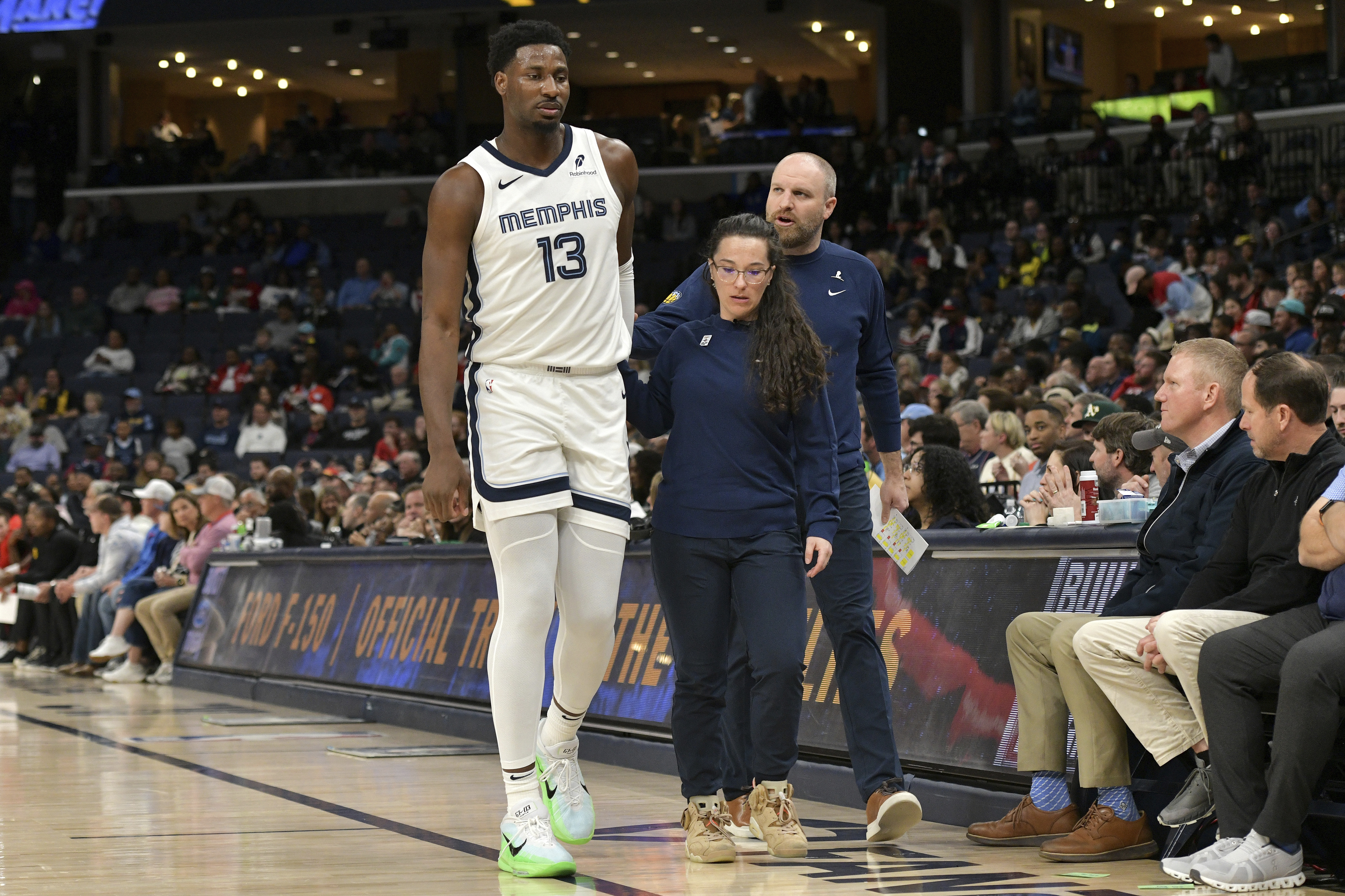 Memphis Grizzlies forward Jaren Jackson Jr. (13) is helped off the court in the first half of an NBA basketball game against the Atlanta Hawks, Monday, March 3, 2025, in Memphis, Tenn. 