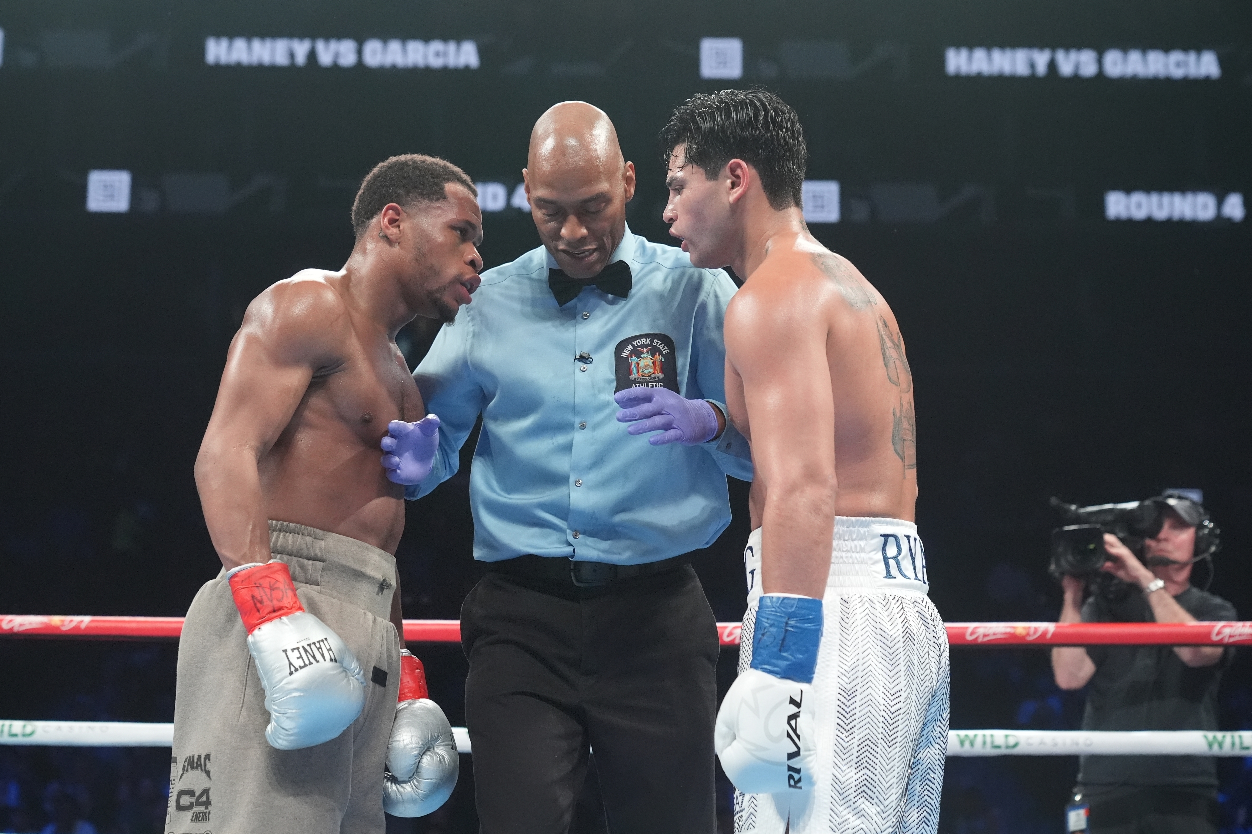 FILE - The referee talks to Devin Haney, left, and Ryan Garcia during the fourth round of a super lightweight boxing match Sunday, April 21, 2024, in New York. 