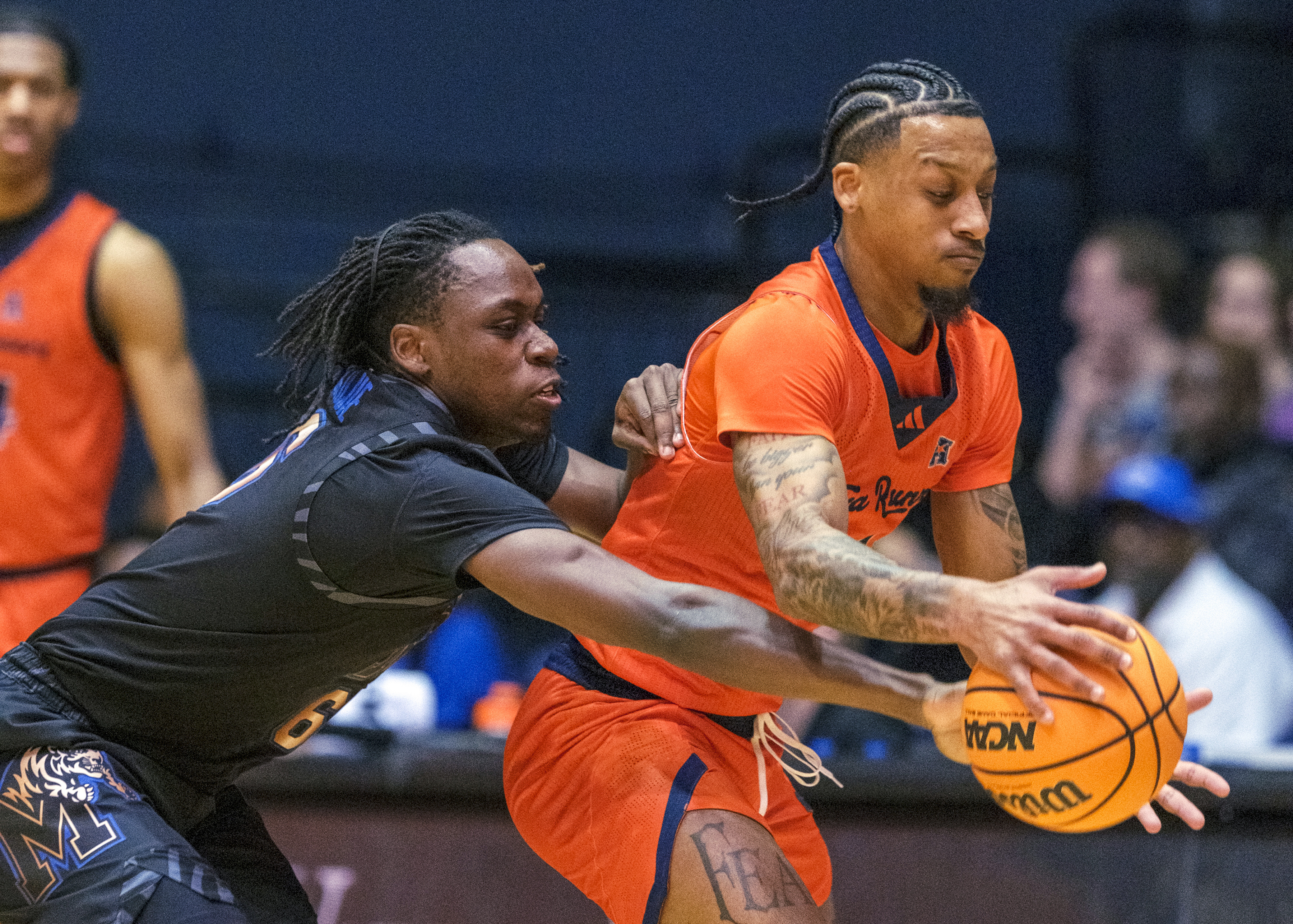 Memphis guard Baraka Okojie (6), left, tries to reach in for the steal against UTSA guard Primo Spears (1) during the first half of an NCAA college basketball game in San Antonio, Texas, Tuesday, March 4, 2025. 