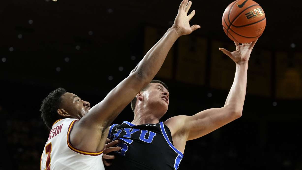 BYU forward Mihailo Boskovic fights for a rebound with Iowa State center Dishon Jackson (1), left, during the first half of an NCAA college basketball game Tuesday, March 4, 2025, in Ames, Iowa.