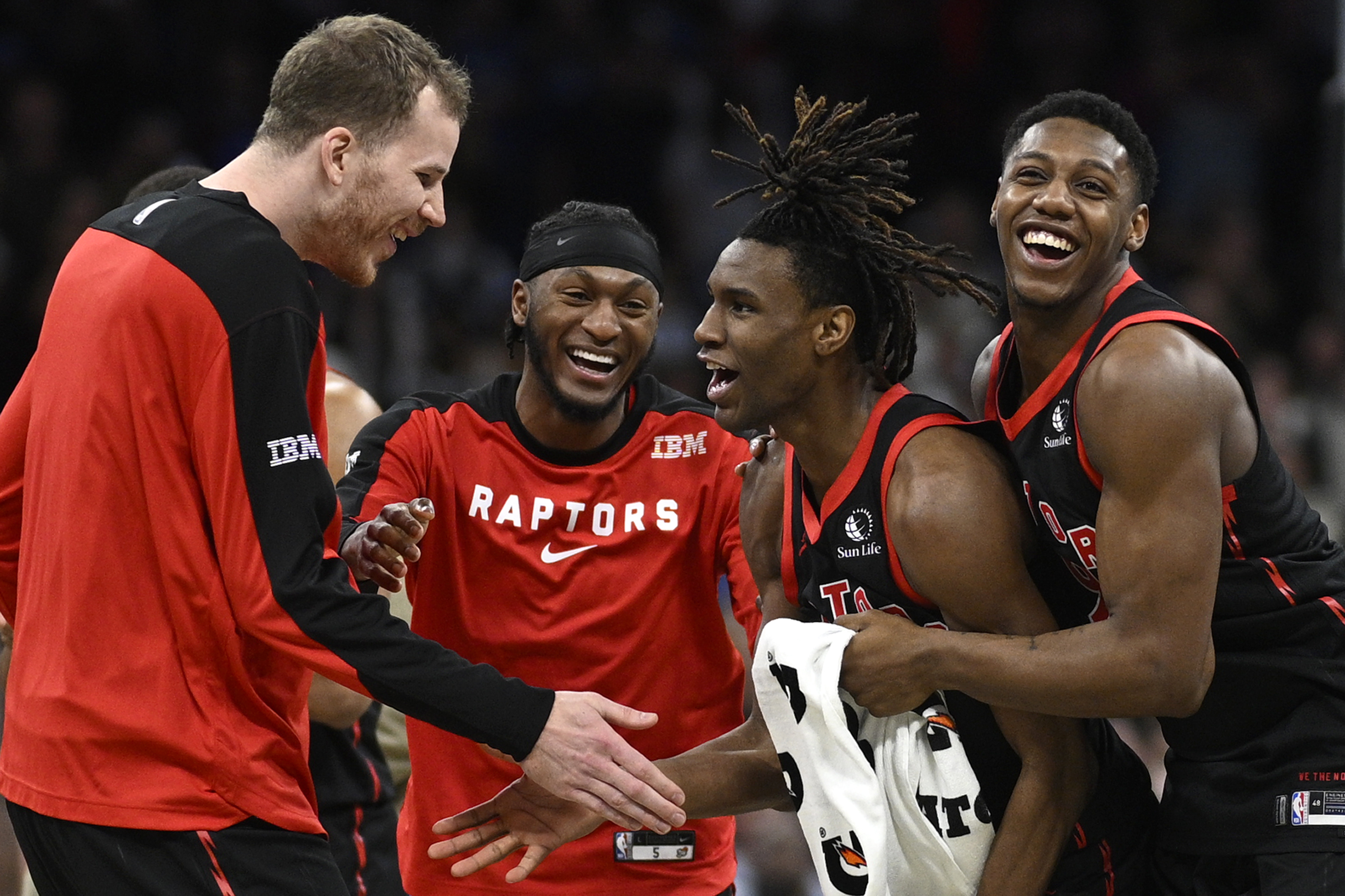 Toronto Raptors guard Ja'Kobe Walter, second from right, is congratulated by center Jakob Poeltl, left, guard Immanuel Quickley, second from left, and guard RJ Barrett, right, after his game-winning shot during the second half of an NBA basketball game against the Orlando Magic, Tuesday, March 4, 2025, in Orlando, Fla.