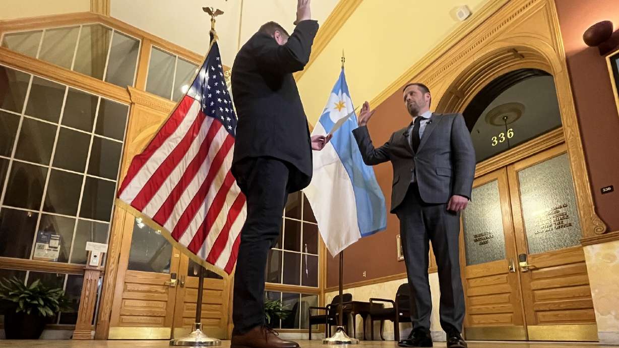 Salt Lake City Police Chief Brian Redd, right, is sworn in to his new role during a brief ceremony outside of the Salt Lake City mayor's office Tuesday night.