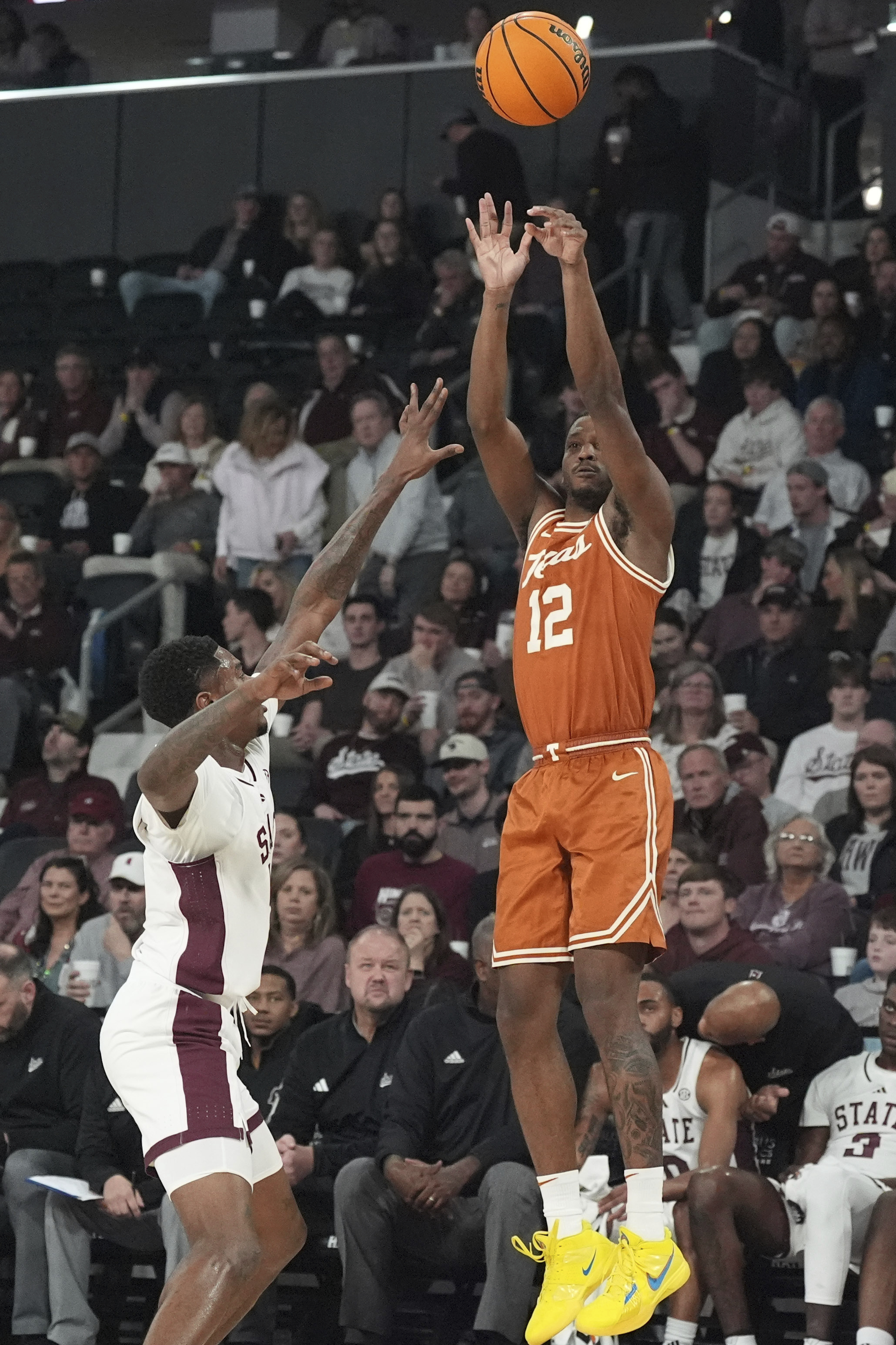 Texas guard Tramon Mark (12) attempts a three-point shot while defended by Mississippi State guard Shawn Jones Jr., left, during the first half of an NCAA college basketball game, Tuesday, March 4, 2025, in Starkville, Miss.