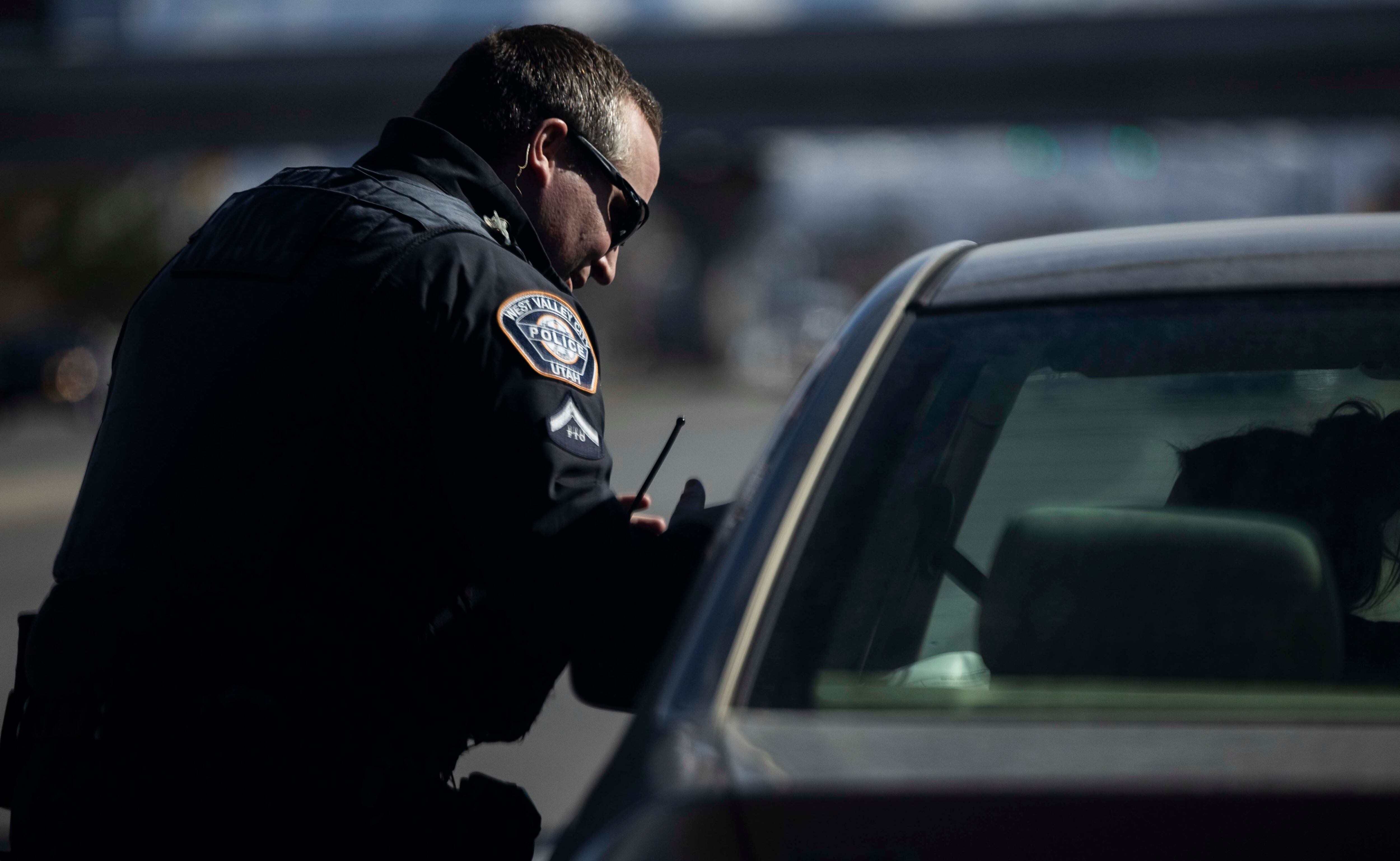 West Valley Police Officer Josh Allen talks to a driver while conducting a traffic stop in West Valley City on Feb. 12.