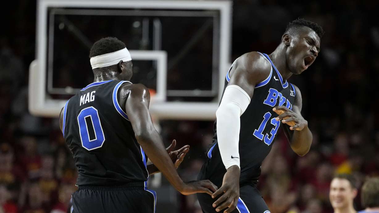 BYU center Keba Keita (13) celebrates with teammate forward Mawot Mag (0) during the first half of an NCAA college basketball game against Iowa State, Tuesday, March 4, 2025, in Ames, Iowa.
