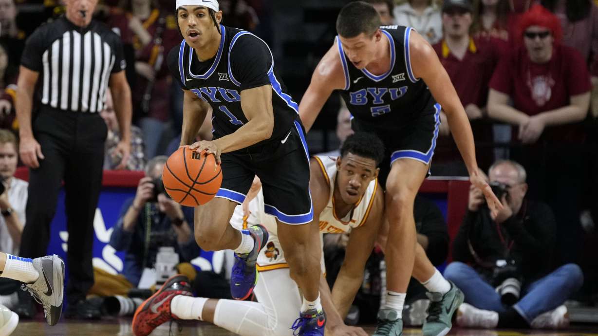BYU guard Trey Stewart (1) drives up court after stealing the ball from Iowa State center Dishon Jackson during the first half of an NCAA college basketball game Tuesday, March 4, 2025, in Ames, Iowa.