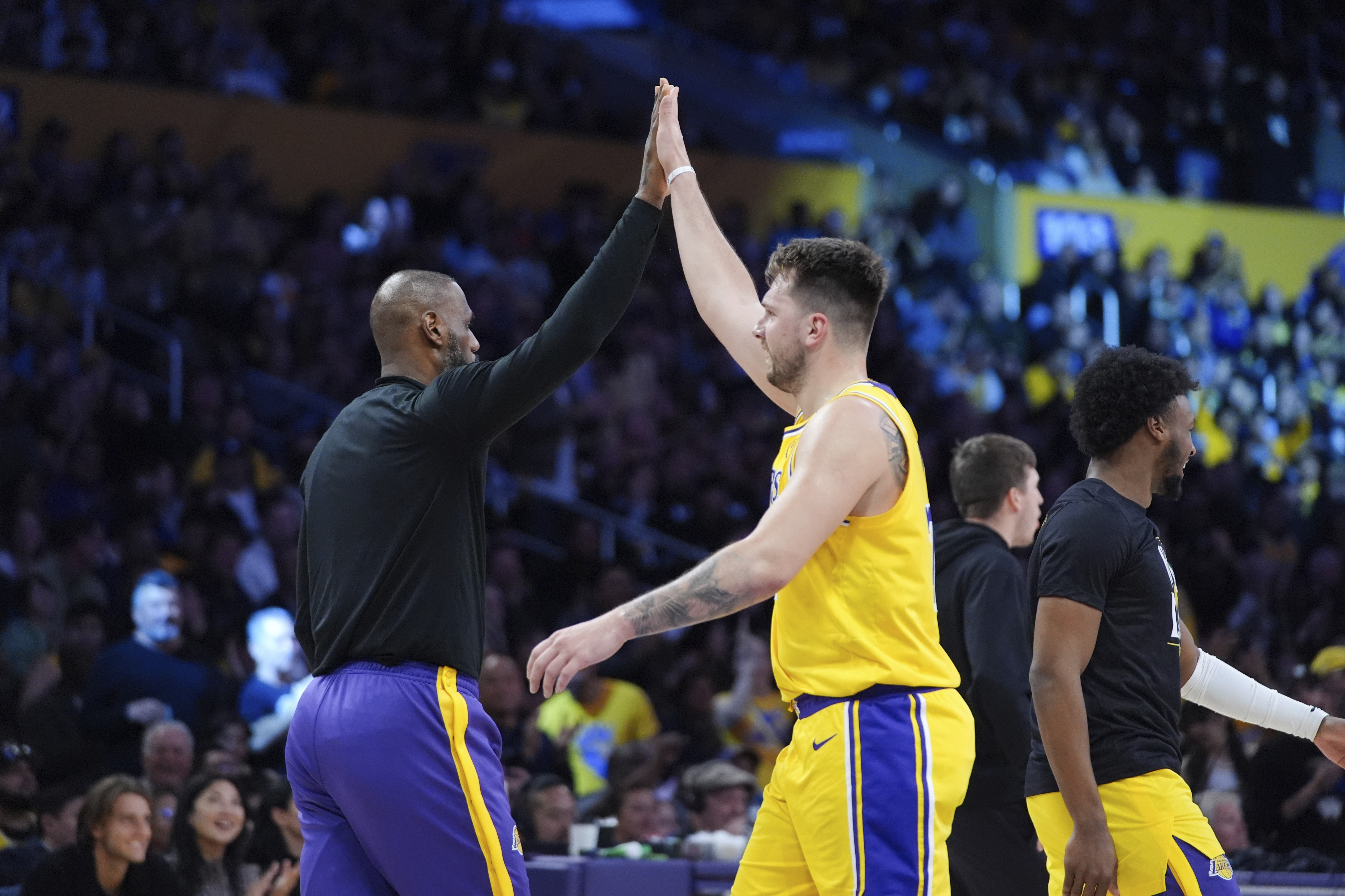 Los Angeles Lakers' LeBron James, left, and Luka Doncic high-five during the first half of an NBA basketball game against the New Orleans Pelicans Tuesday, March 4, 2025, in Los Angeles.