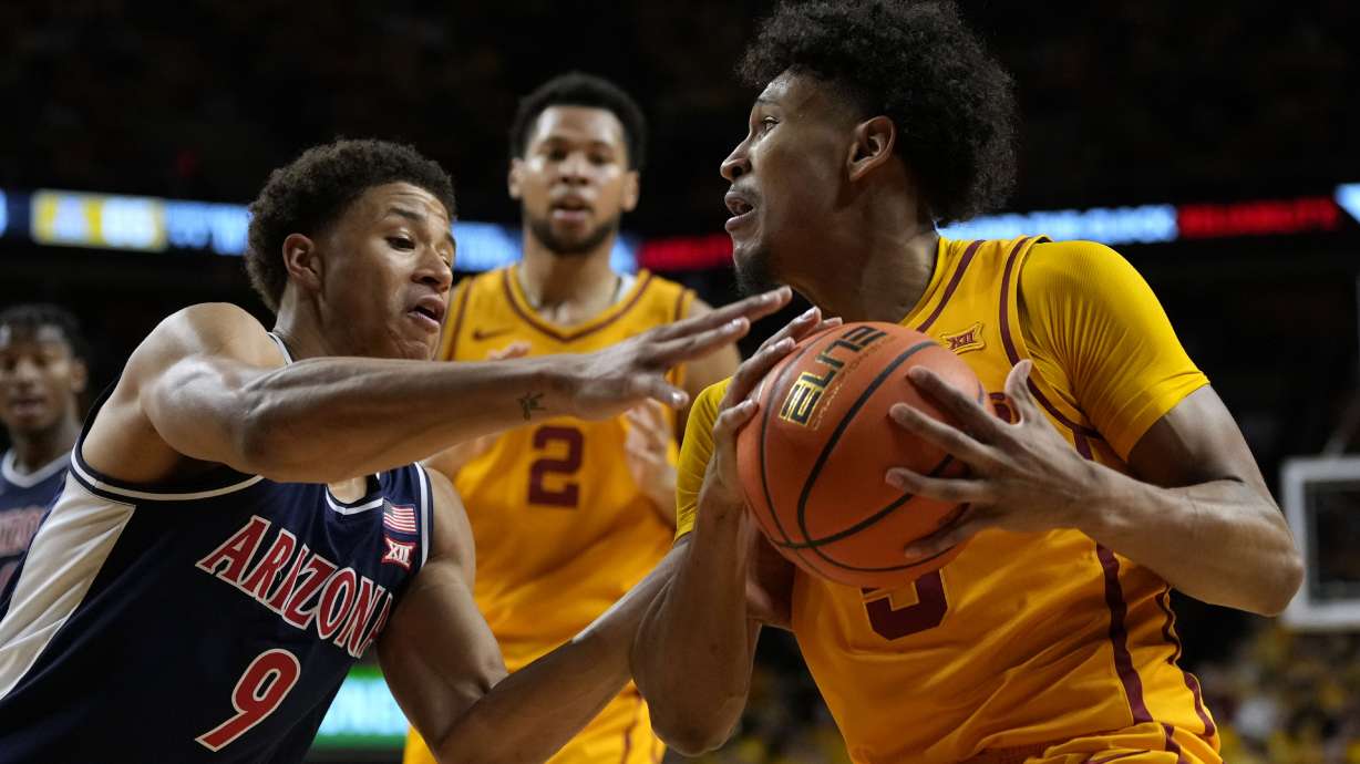 Iowa State guard Curtis Jones, right, is fouled by Arizona forward Carter Bryant (9) while driving to the basket during the second half of an NCAA college basketball game Saturday, March 1, 2025, in Ames, Iowa.