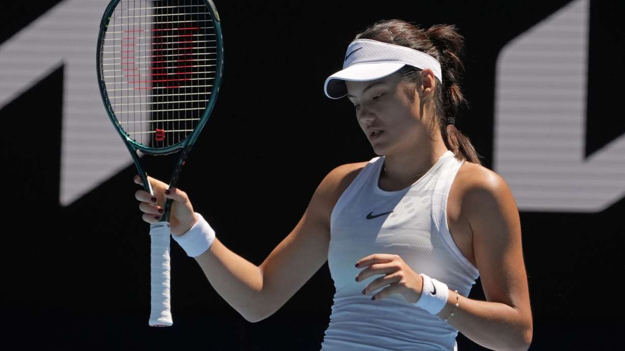 FILE - Emma Raducanu of Britain reacts during her third round match against Iga Swiatek of Poland at the Australian Open tennis championship in Melbourne, Australia, Saturday, Jan. 18, 2025.