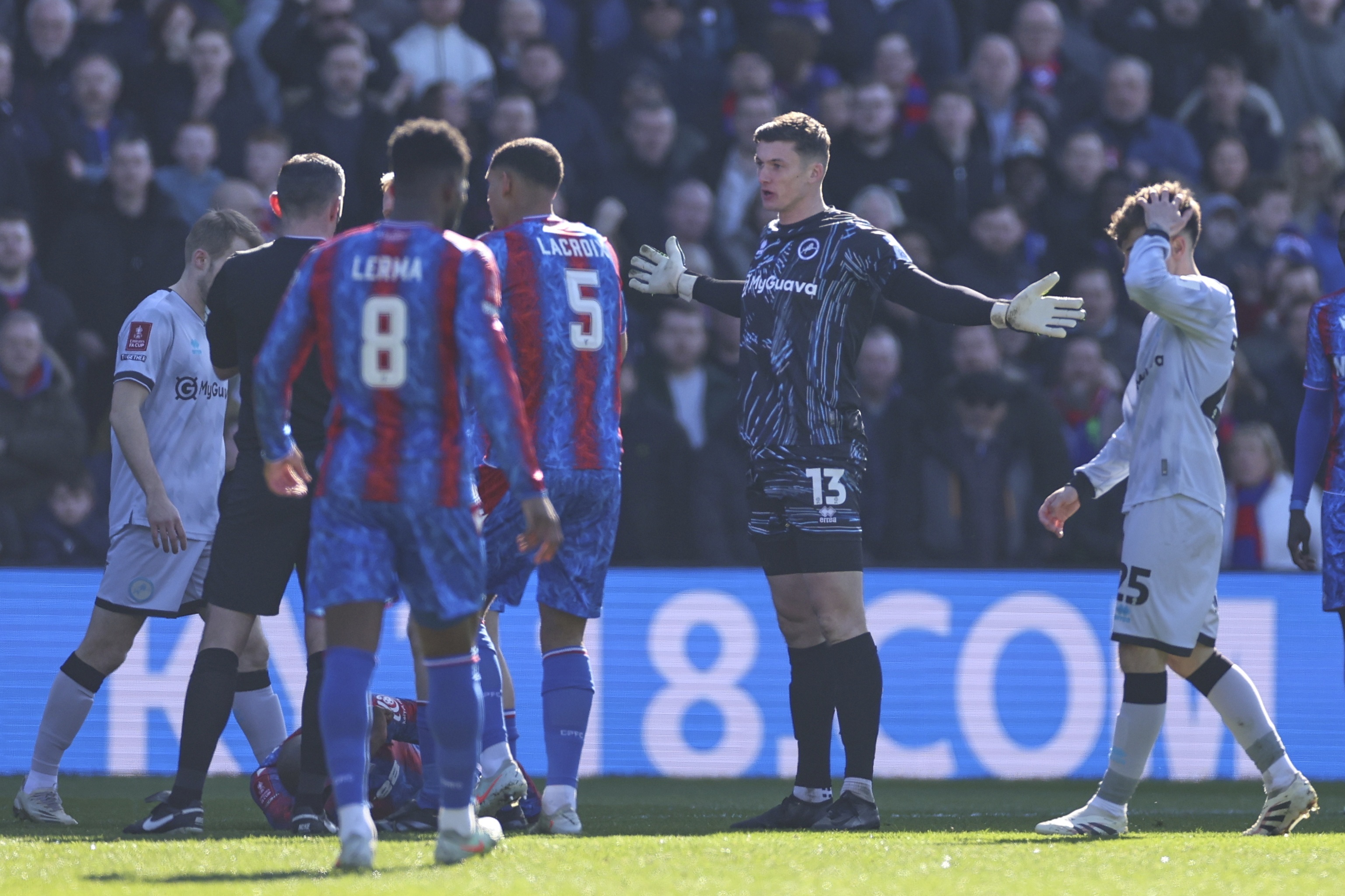 Millwall goalkeeper Liam Roberts reacts before getting a red card for a challenge of Crystal Palace's Jean-Philippe Mateta during the English FA Cup soccer match between Crystal Palace and Millwall at Selhurst Park, London, England, Saturday, March 1, 2025. 