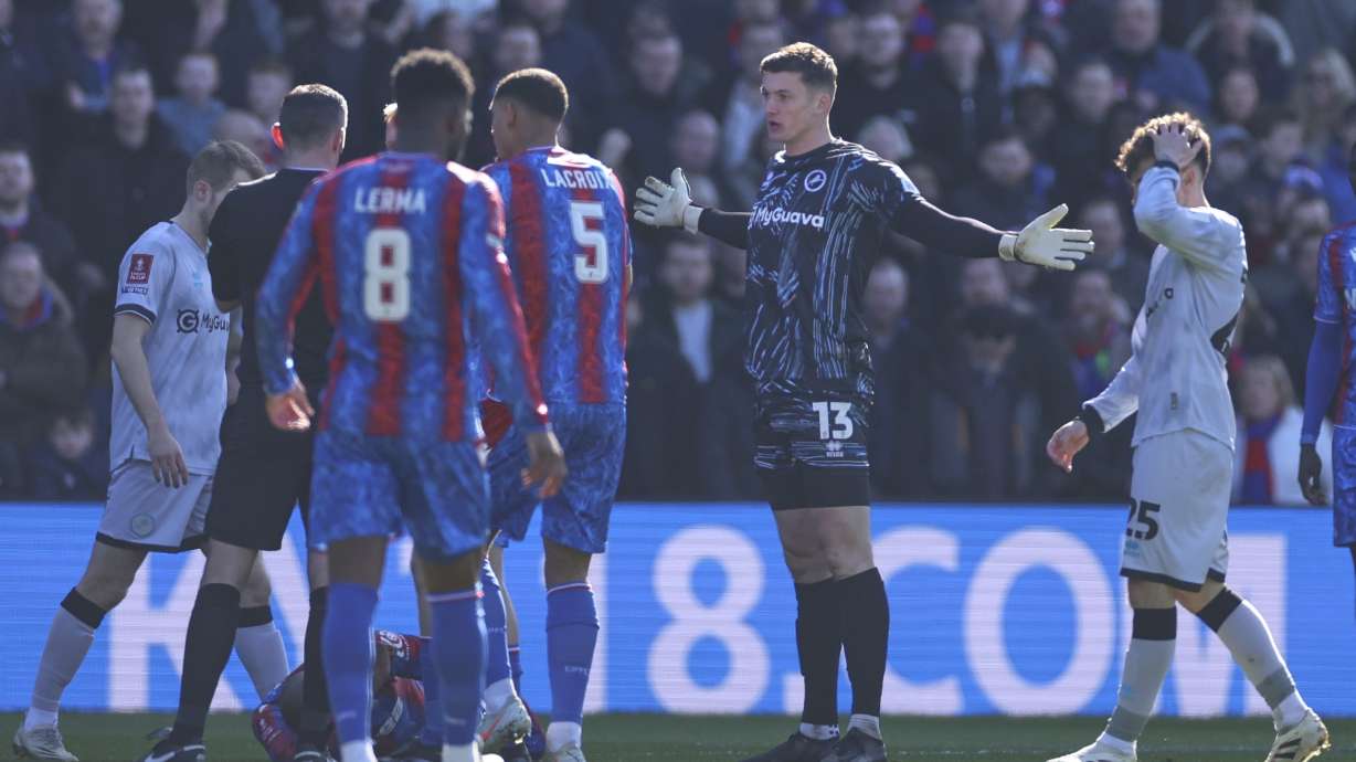 Millwall goalkeeper Liam Roberts reacts before getting a red card for a challenge of Crystal Palace's Jean-Philippe Mateta during the English FA Cup soccer match between Crystal Palace and Millwall at Selhurst Park, London, England, Saturday, March 1, 2025.