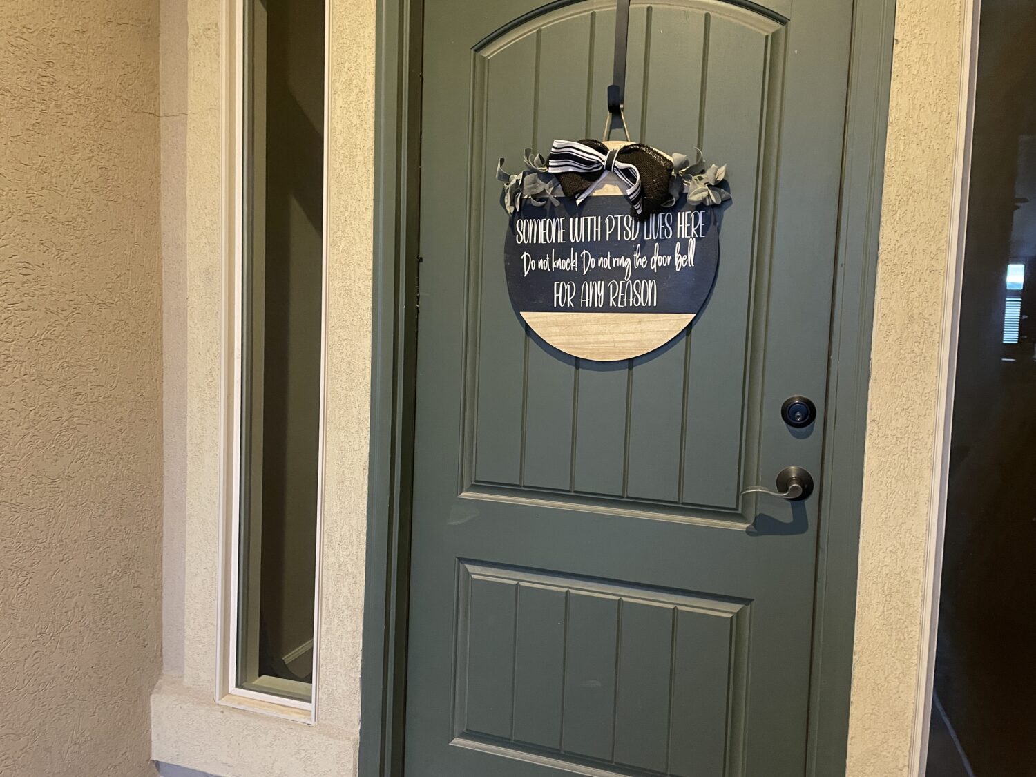 A sign on Karina Thompson's door in Lehi Tuesday warns others not to knock or ring the doorbell.