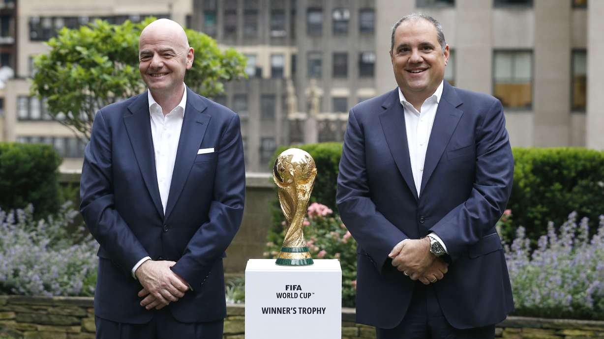 FILE - FIFA President Gianni Infantino,, left, and Vice President Vittorio Montagliani stand with the FIFA World Cup trophy Thursday, June 16, 2022, in New York.