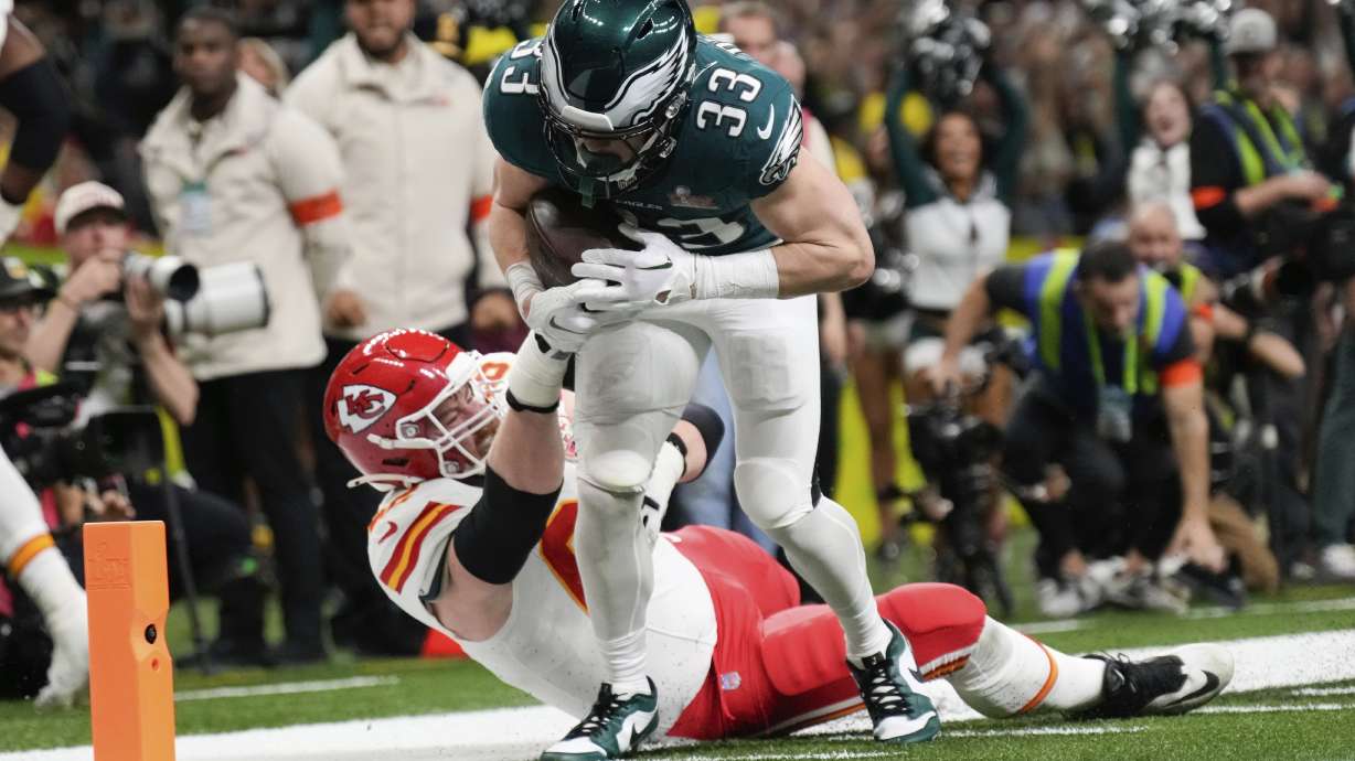 Philadelphia Eagles defensive back Cooper DeJean (33) scores a touchdown past Kansas City Chiefs guard Joe Thuney (62) after intercepting a pass during the first half of the NFL Super Bowl 59 football game against the Kansas City Chiefs, Sunday, Feb. 9, 2025, in New Orleans.