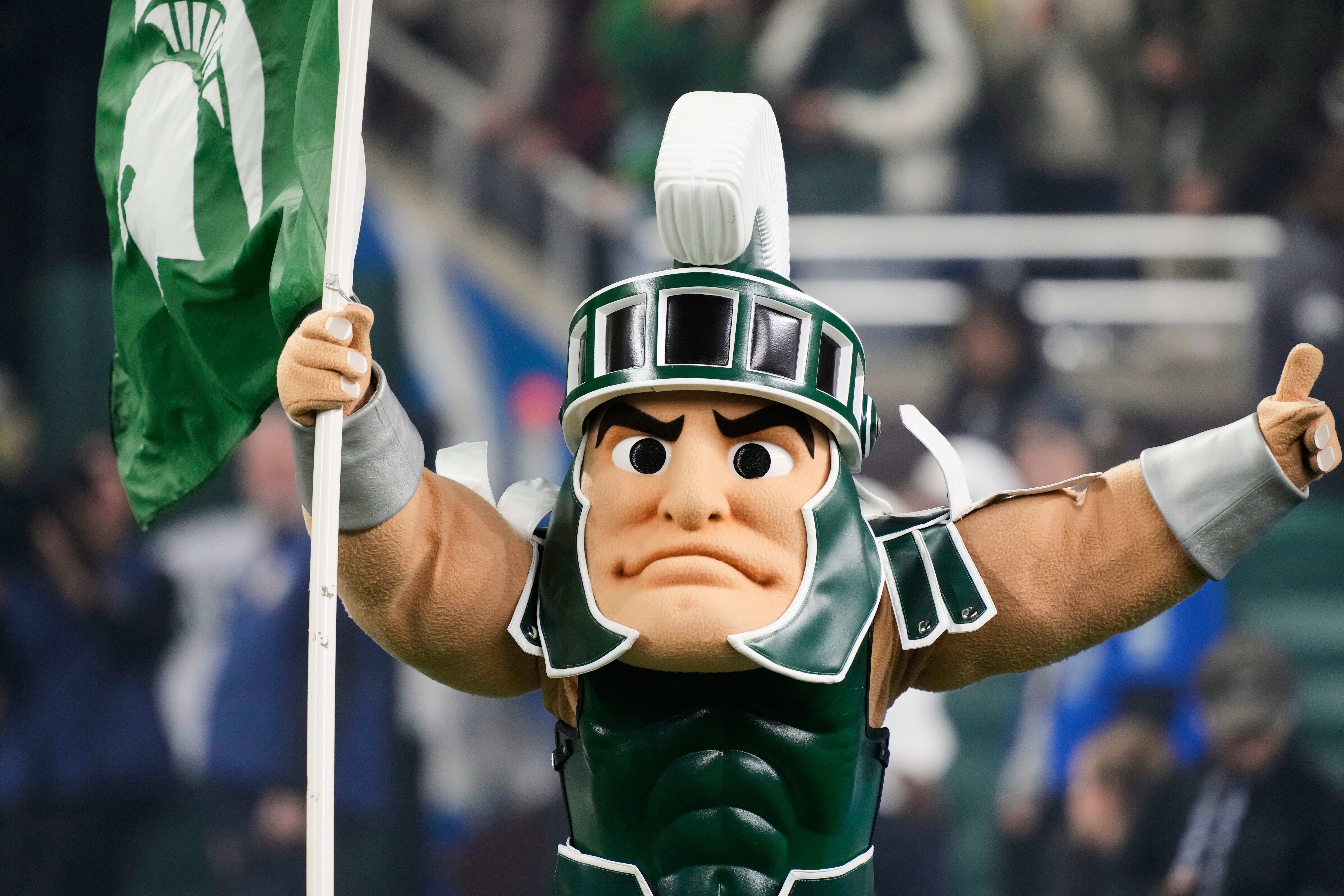 Sparty, the Michigan State mascot, runs out onto the field before the first half of an NCAA college football game against Penn State, Friday, Nov. 24, 2023, in Detroit.