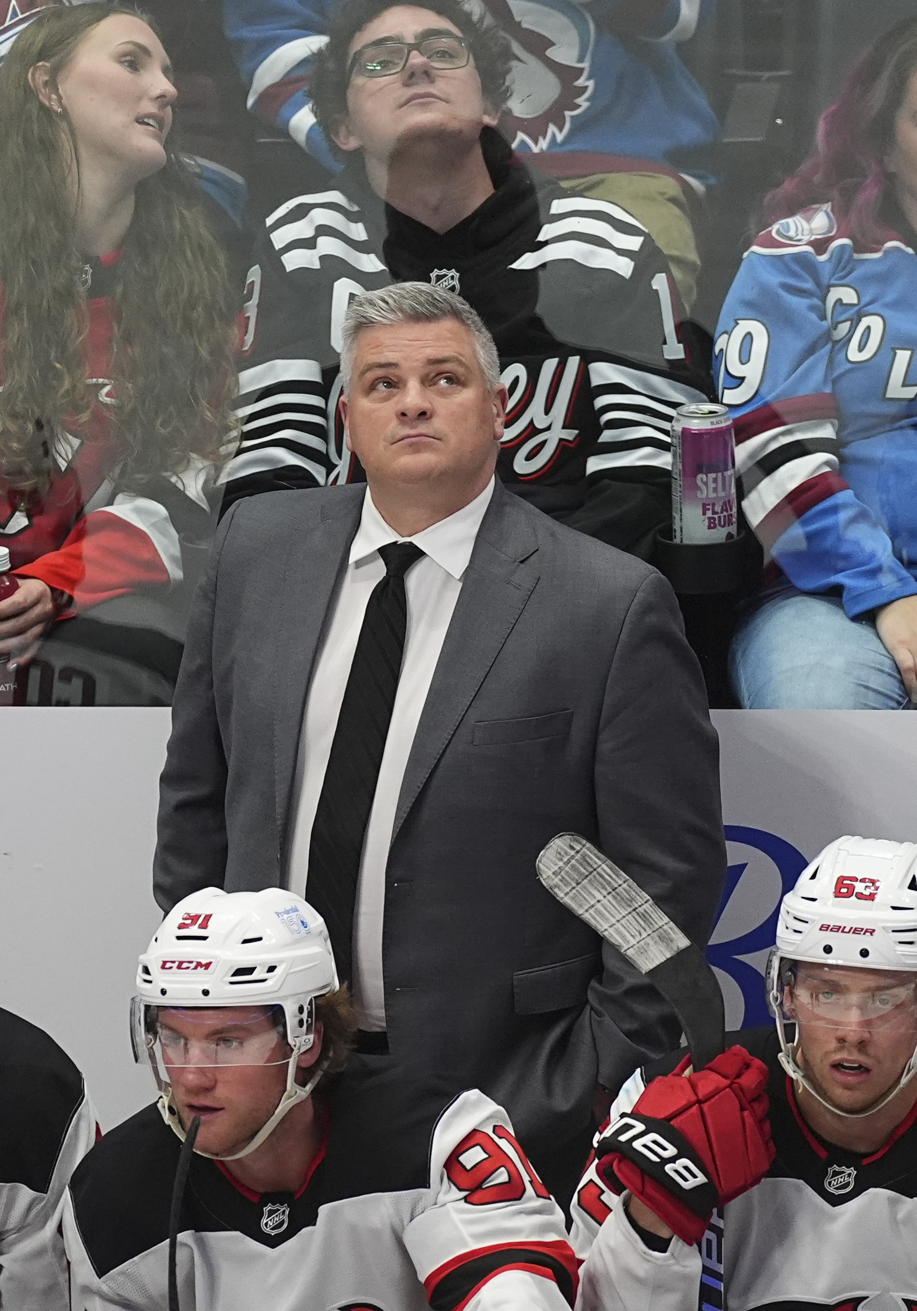 New Jersey Devils head coach Sheldon Keefe looks on from the team box in the third period of an NHL hockey game against the Colorado Avalanche Wednesday, Feb. 26, 2025, in Denver.