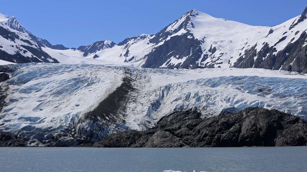A chunk of ice floats past the Portage Glacier near Girdwood, Alaska, on June 14, 2021. Alaska State Troopers say three skiers were swept away and likely killed by an avalanche near Girdwood Tuesday.