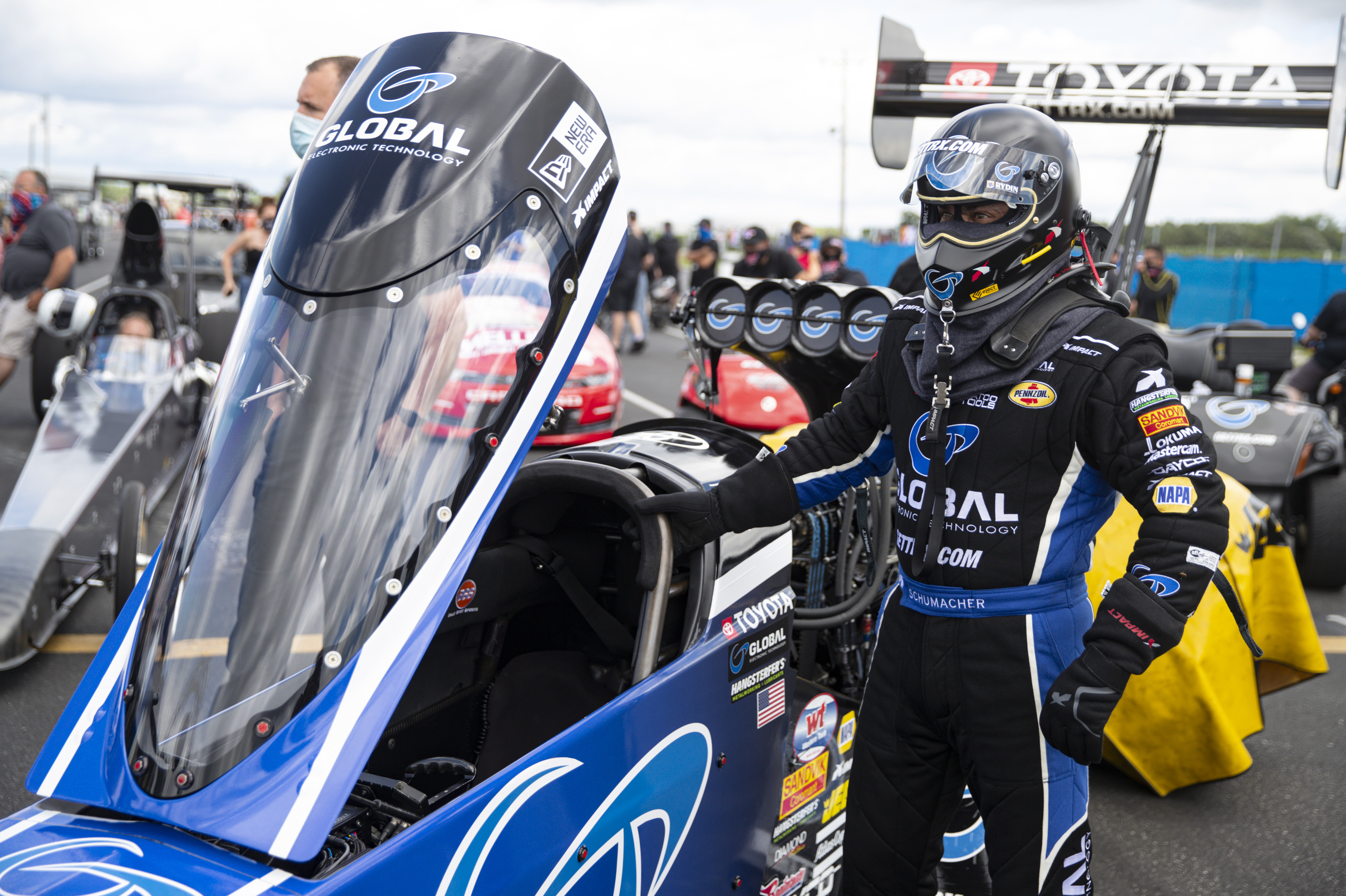 FILE - Tony Schumacher waits to climbs into his Top Fuel dragster during practice for an NHRA drag racing event in Brownsburg, Ind., July 10, 2020.