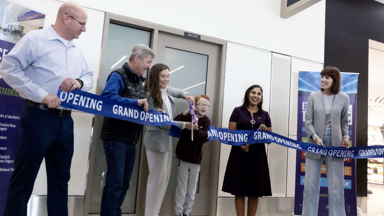Salt Lake City Mayor Erin Mendenhall and Winnie Moore cut the ribbon at the opening of a sensory-inclusive space at the Salt Lake City International Airport on Wednesday.