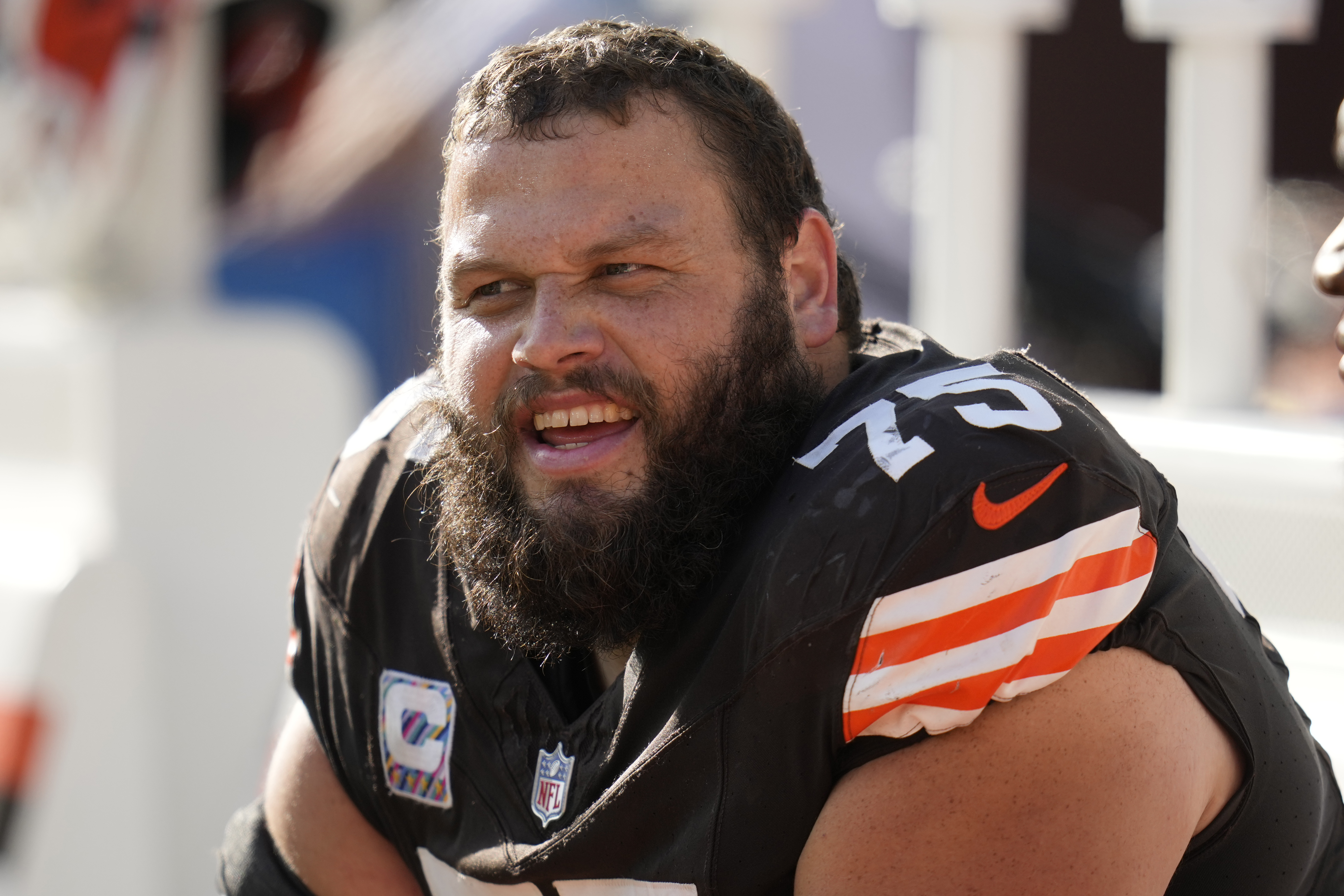Cleveland Browns guard Joel Bitonio (75) smiles on the sideline during the second half of an NFL football game against the Baltimore Ravens, Sunday, Oct. 27, 2024, in Cleveland. 