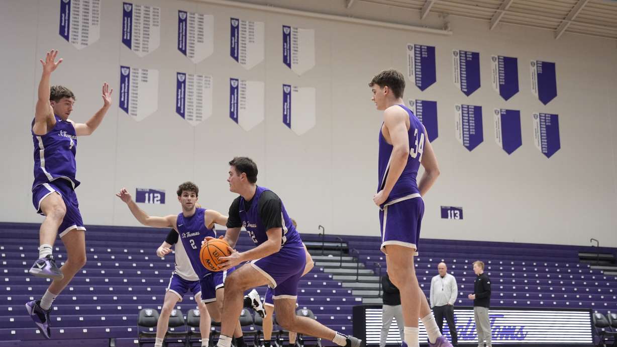 St. Thomas forward, Carter Bjerke, center left, takes part in drills during NCAA college basketball practice, Wednesday, Feb. 26, 2025, in St. Paul, Minn.