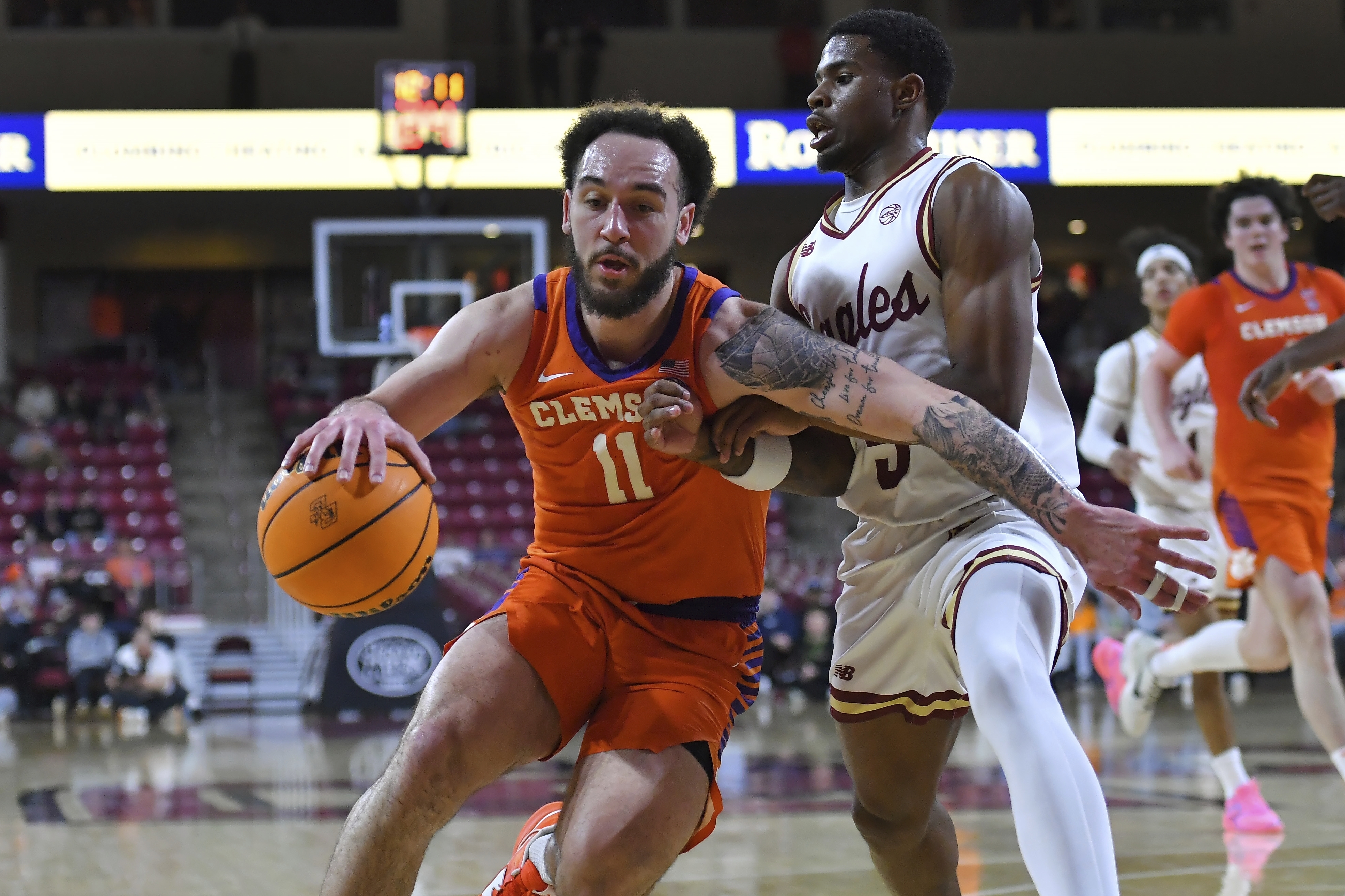 Clemson guard Jaeden Zackery (11) drives past Boston College guard Fred Payne (5) in the second half of an NCAA college basketball game, Wednesday, March 5, 2025, in Boston.