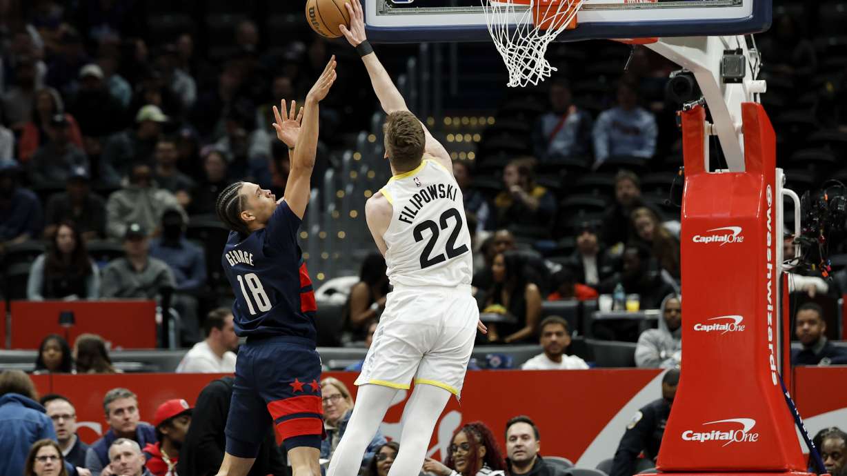 Washington Wizards forward Kyshawn George (18) has his shot blocked by Utah Jazz forward Kyle Filipowski (22) during the first half of an NBA basketball game, Wednesday, Mar. 5, 2025, in Washington.