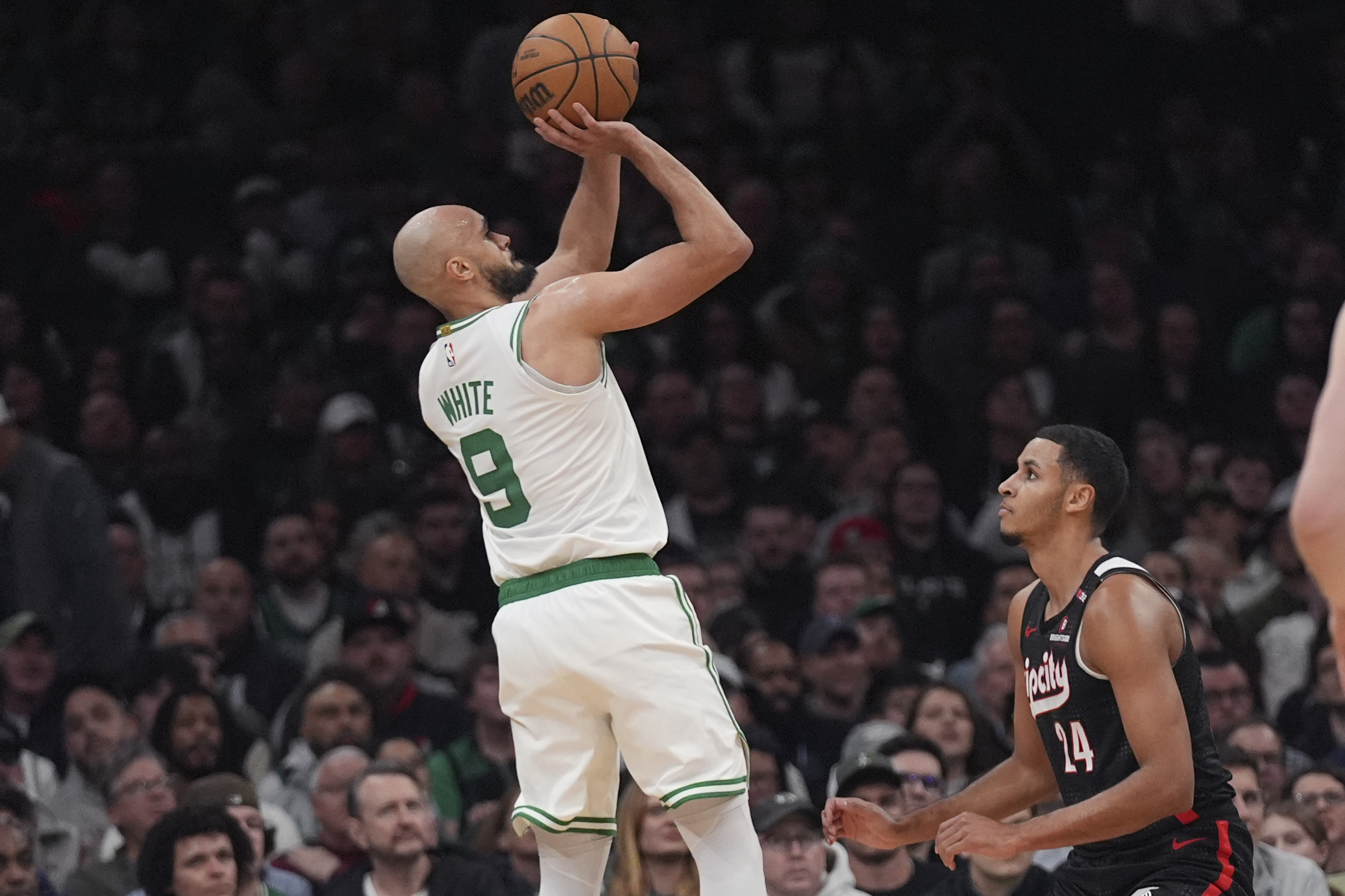 Boston Celtics guard Derrick White (9) takes a 3-point shot over Portland Trail Blazers forward Kris Murray (24) during the first half of an NBA basketball game, Wednesday, March 5, 2025, in Boston.