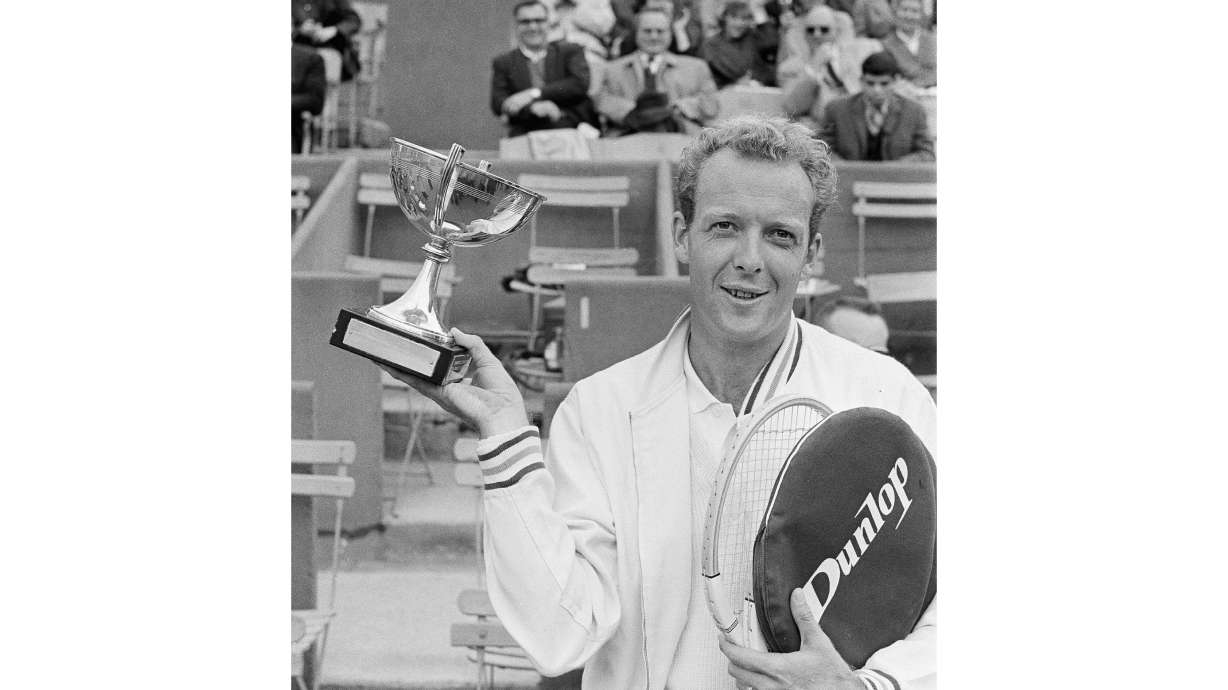 FILE - Australian tennis ace Fred Stolle holds the trophy he won in the final of the men's singles of the French tournament at Roland Garros stadium in Paris, May 29, 1965.