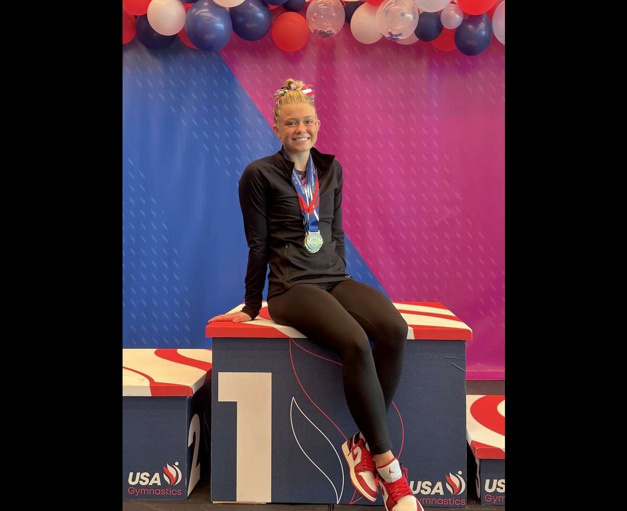 Avery Neff poses with medals she won following a USA Gymnastics meet.