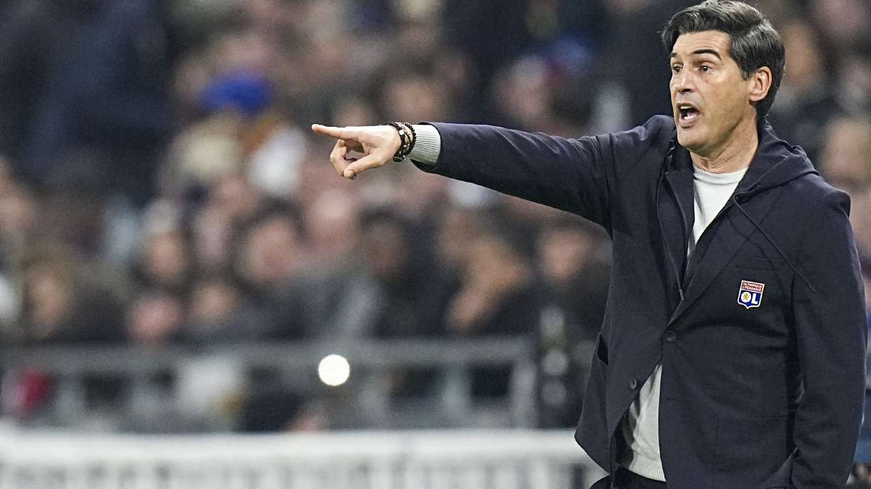 Lyon's head coach Paulo Fonseca gives instructions to his players during the French League One soccer match between Lyon and Paris Saint-Germain at the Groupama stadium, outside Lyon, France, Sunday, Feb. 23, 2025.