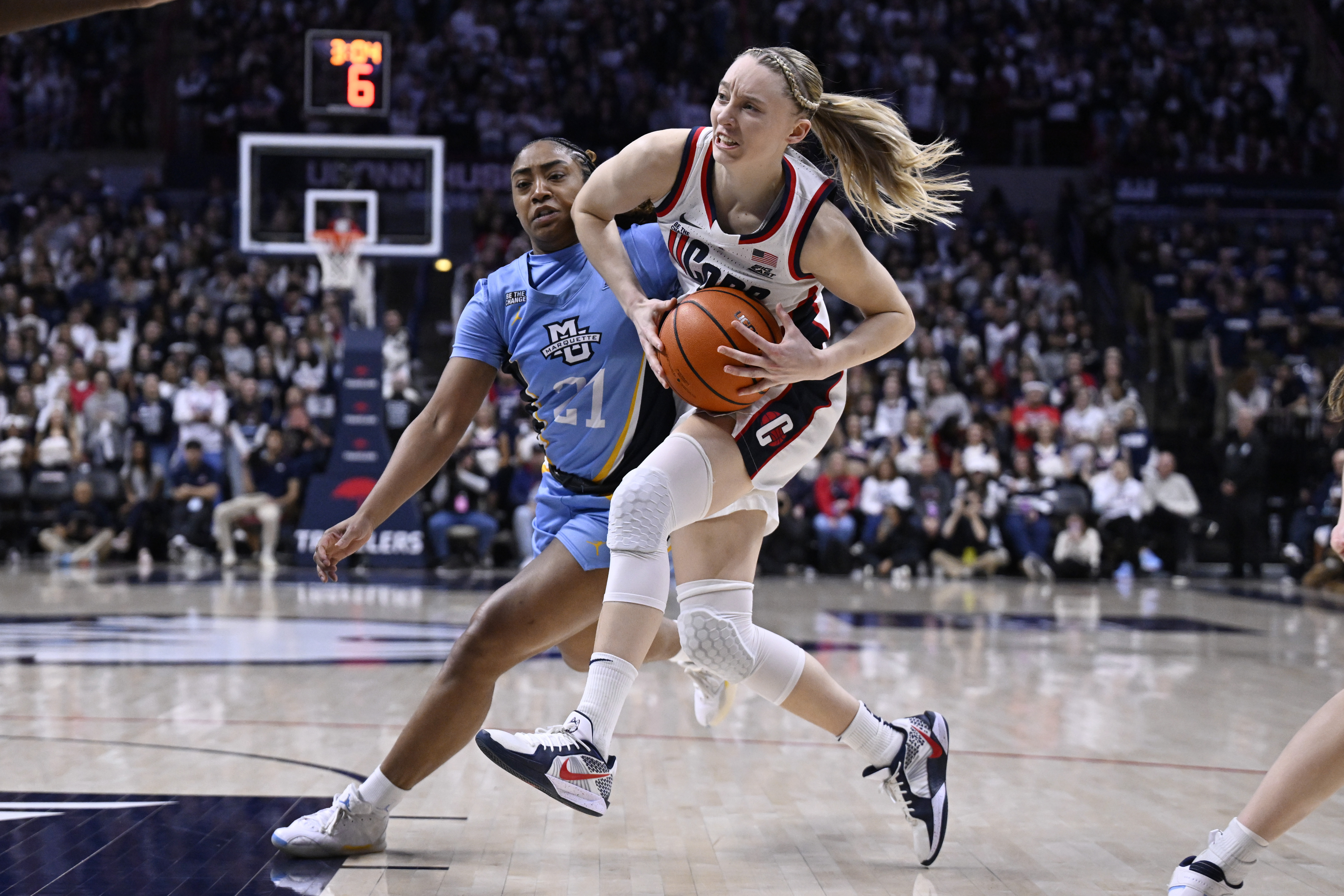UConn guard Paige Bueckers, right,drives to the basket as Marquette guard Kennedi Perkins (21) defends during the second half an NCAA college basketball game, Sunday, March 2, 2025, in Storrs, Conn. 