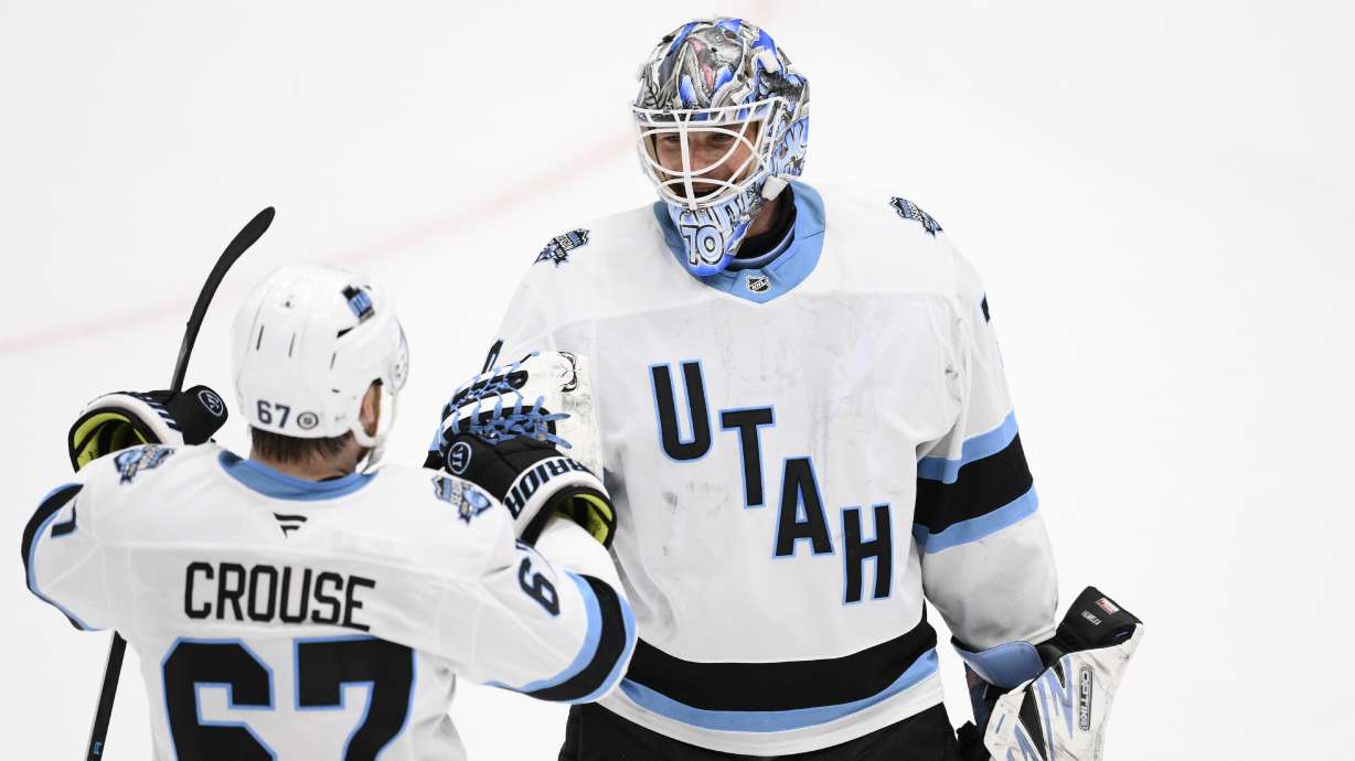 Utah Hockey Club goaltender Karel Vejmelka, right, celebrates with left wing Lawson Crouse (67) after an NHL hockey game against the Washington Capitals, Sunday, Feb. 9, 2025, in Washington.