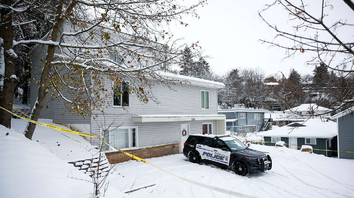 Police tape surrounds the residence where four University of Idaho students were killed as Moscow Police monitor the scene on Nov. 30, 2022. A recently unsealed defense motion in the capital murder case reveals new details.