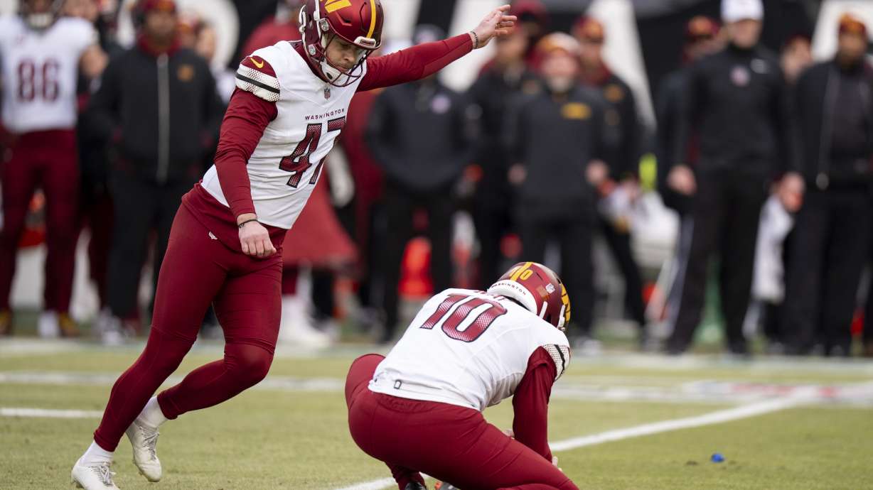 Washington Commanders kicker Zane Gonzalez (47) kicks the field goal with punter Tress Way (10) holding during the NFL championship playoff football game against the Philadelphia Eagles, Sunday, Jan. 26, 2025, in Philadelphia.
