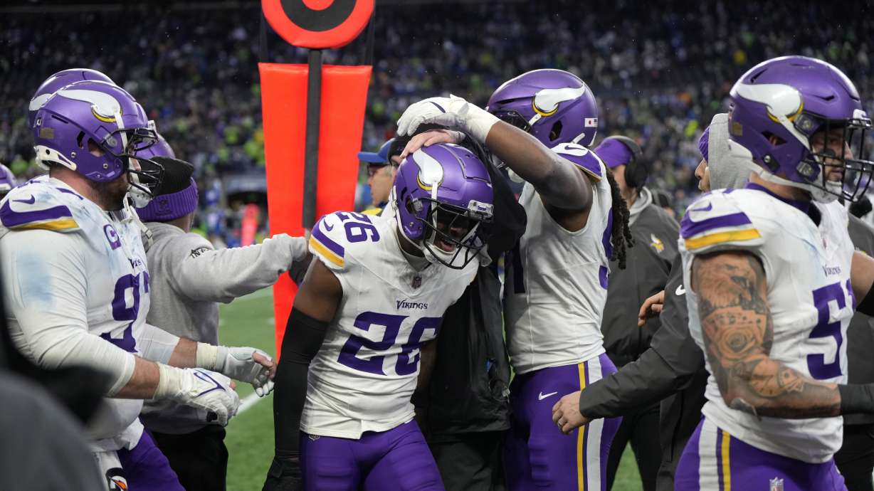 FILE - Minnesota Vikings safety Theo Jackson (26) celebrates with teammates after intercepting a pass during the second half of an NFL football game against the Seattle Seahawks, Dec. 22, 2024, in Seattle.