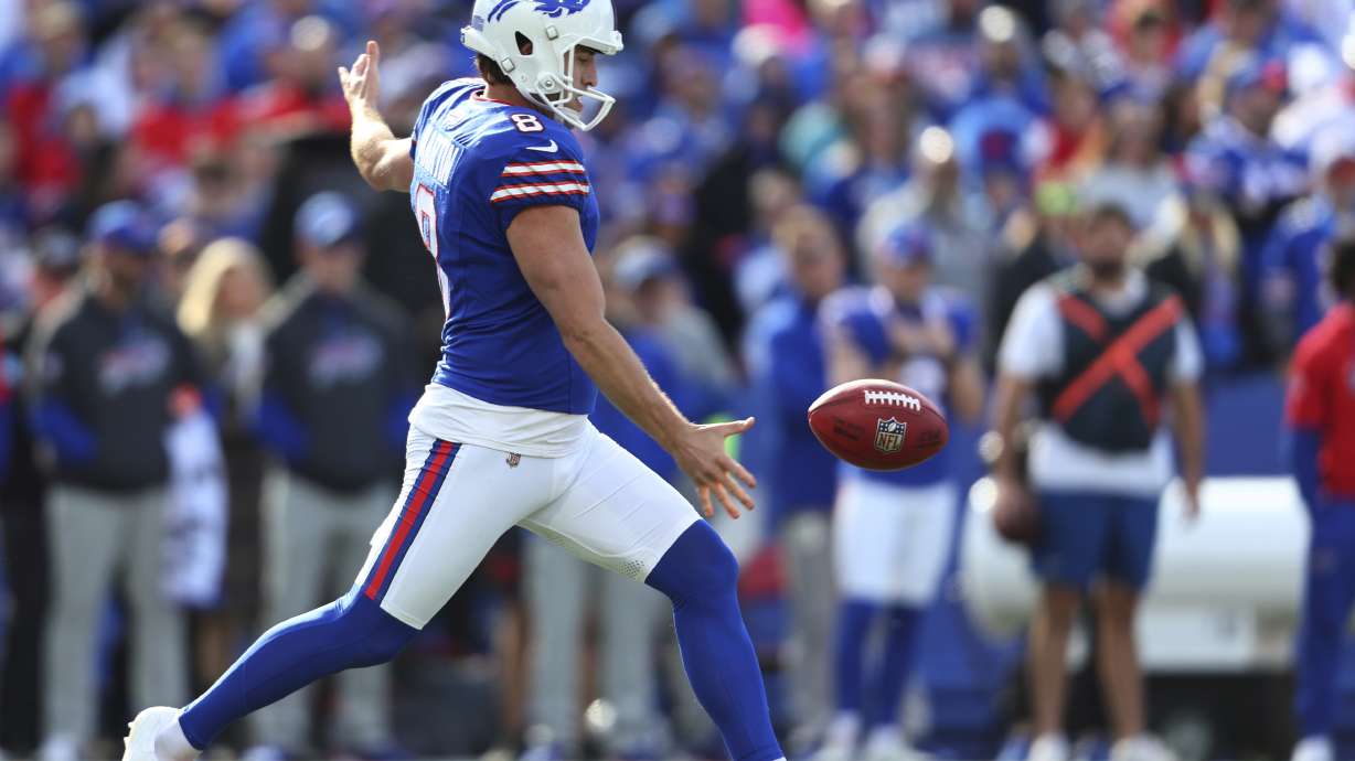 FILE - Buffalo Bills punter Sam Martin punts the ball during the first half of an NFL football game against the Miami Dolphins in Orchard Park, N.Y.,Nov. 3, 2024.