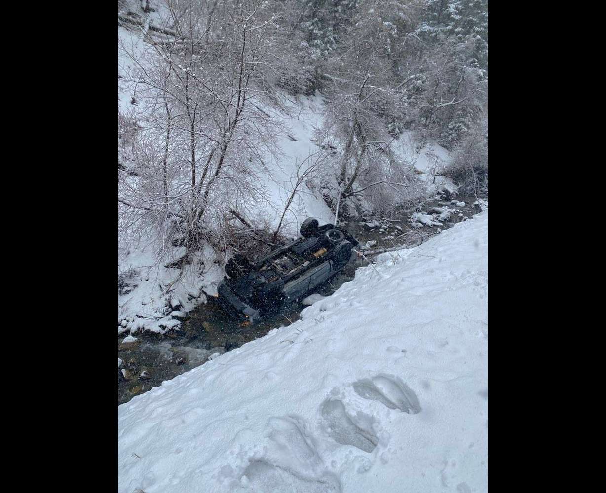 One of the vehicles that slid into the water in Provo Canyon on Thursday is shown upside-down.