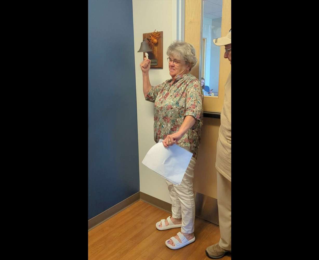 Eva Brinley rings a bell signifying she has finished her cancer treatment.