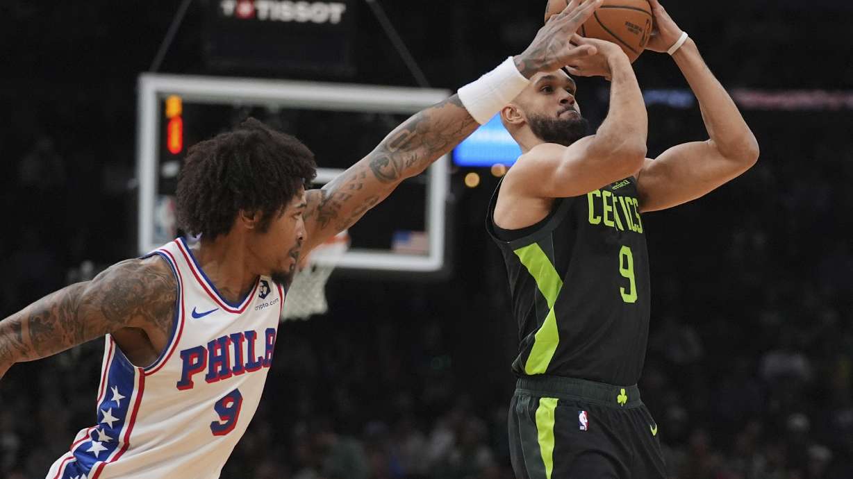 Boston Celtics guard Derrick White, right, is pressured by Philadelphia 76ers guard Kelly Oubre Jr. on a shot during the first half of an NBA basketball game, Thursday, March 6, 2025, in Boston.