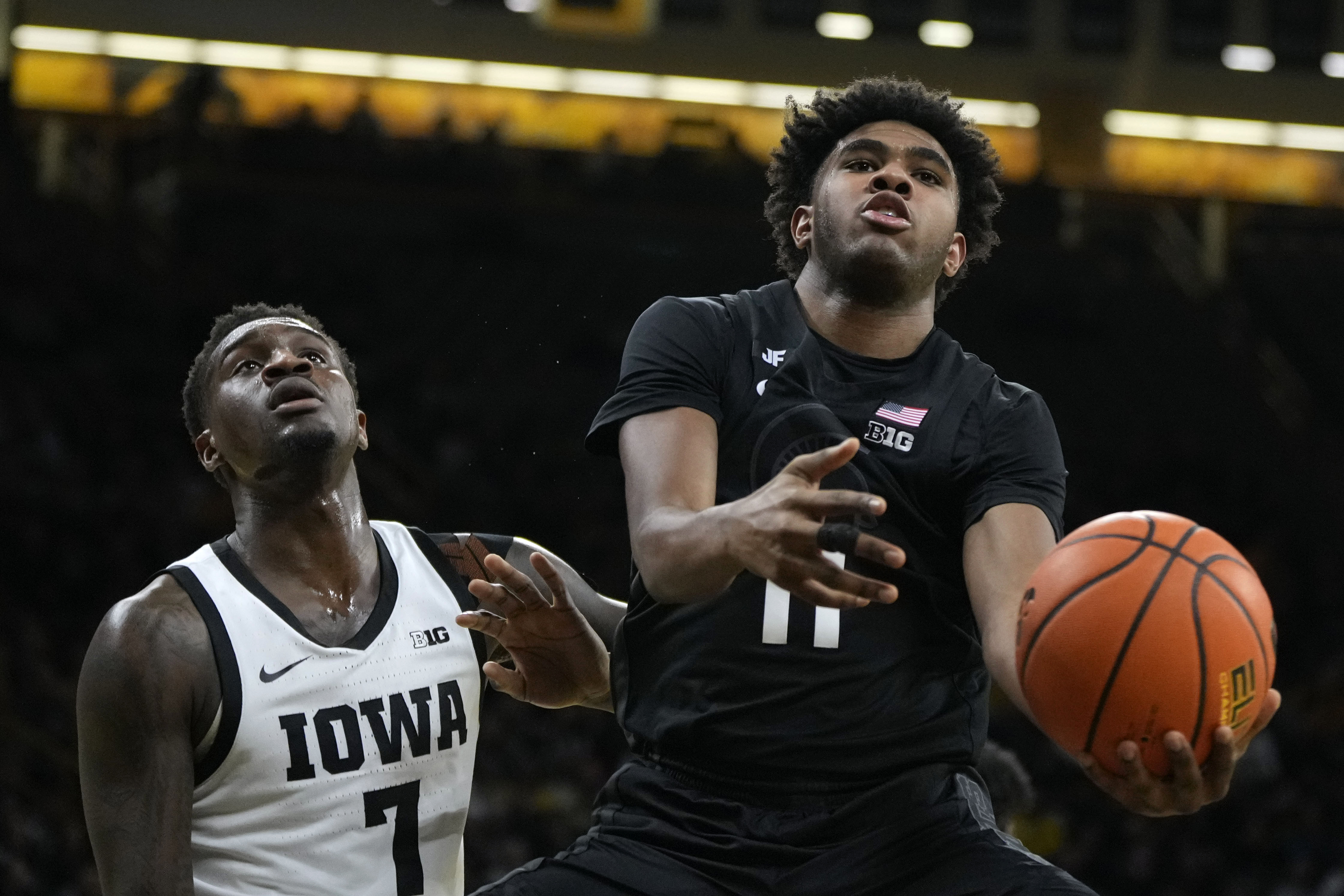 Michigan State guard Jase Richardson (11) drives past Iowa forward Seydou Traore (7) during the first half of an NCAA college basketball game, Thursday, March 6, 2025, in Iowa City, Iowa. 
