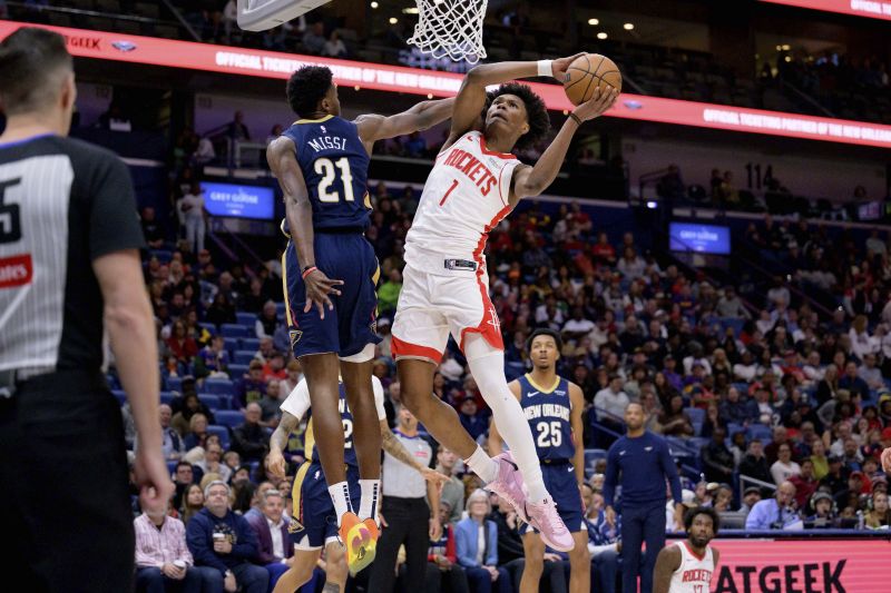 Houston Rockets forward Amen Thompson (1) gets around New Orleans Pelicans center Yves Missi (21) for a basket during the first half of an NBA basketball game in New Orleans, Thursday, March 6, 2025. - AP Photo/Matthew Hinton