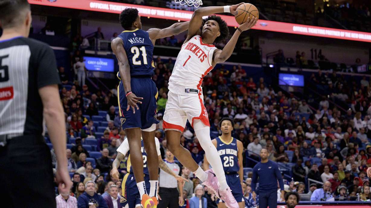 Houston Rockets forward Amen Thompson (1) gets around New Orleans Pelicans center Yves Missi (21) for a basket during the first half of an NBA basketball game in New Orleans, Thursday, March 6, 2025.