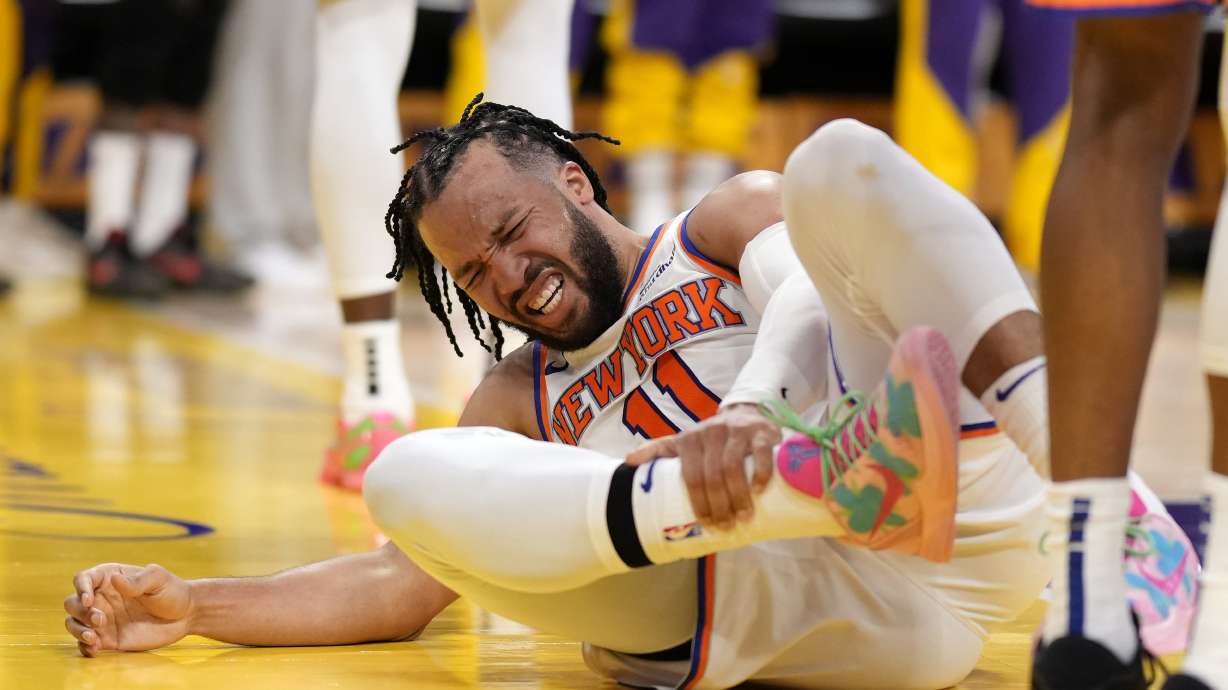 New York Knicks guard Jalen Brunson writhes in pain after getting injured during the second half of an NBA basketball game against the Los Angeles Lakers, Thursday, March 6, 2025, in Los Angeles.