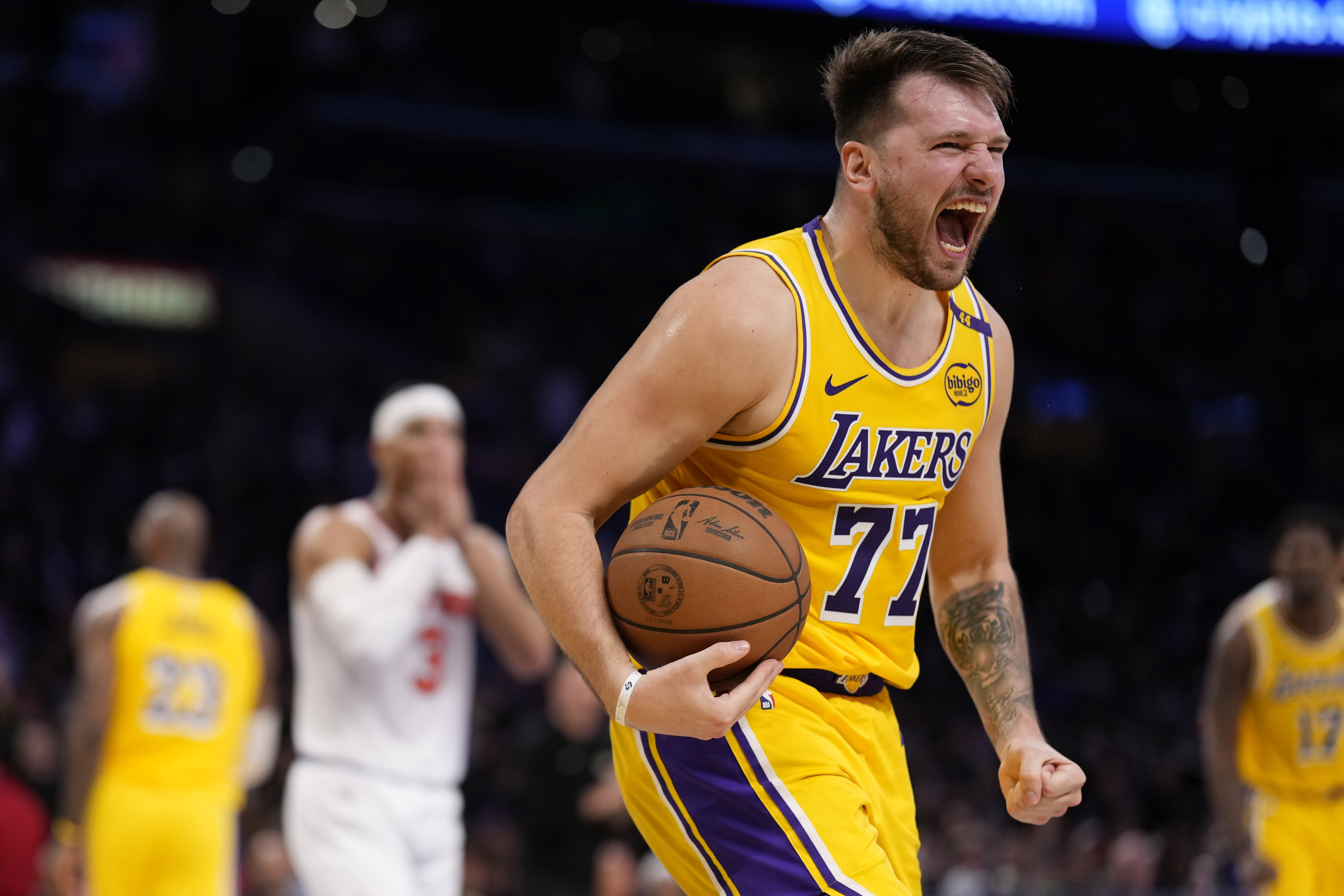 Los Angeles Lakers guard Luka Doncic, right, reacts along with New York Knicks guard Josh Hart after the Knicks turned over the ball during the second half of an NBA basketball game Thursday, March 6, 2025, in Los Angeles.