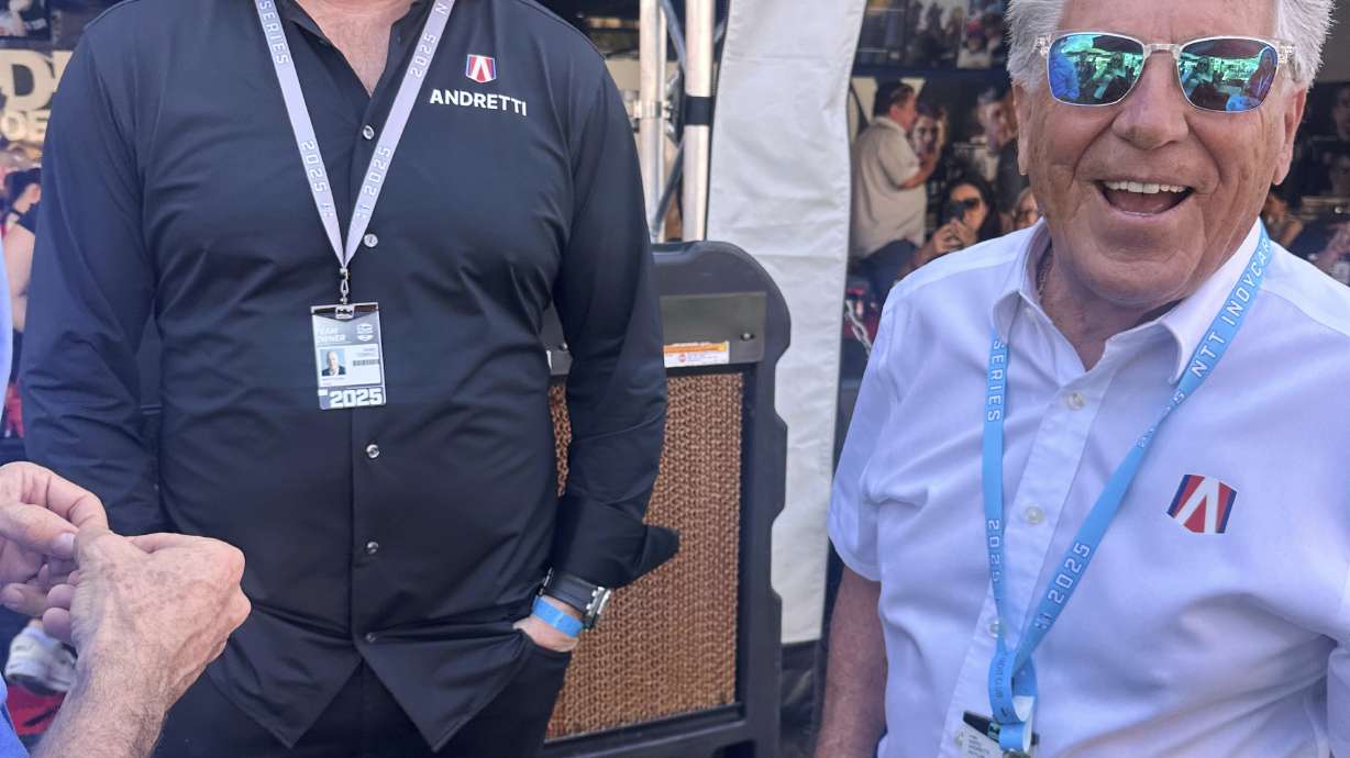 Dan Towriss, the new owner of Andretti Global, laughs with Mario Andretti before the IndyCar Series season-opening race Sunday March 2, 2025, in St. Petersburg, Fla.