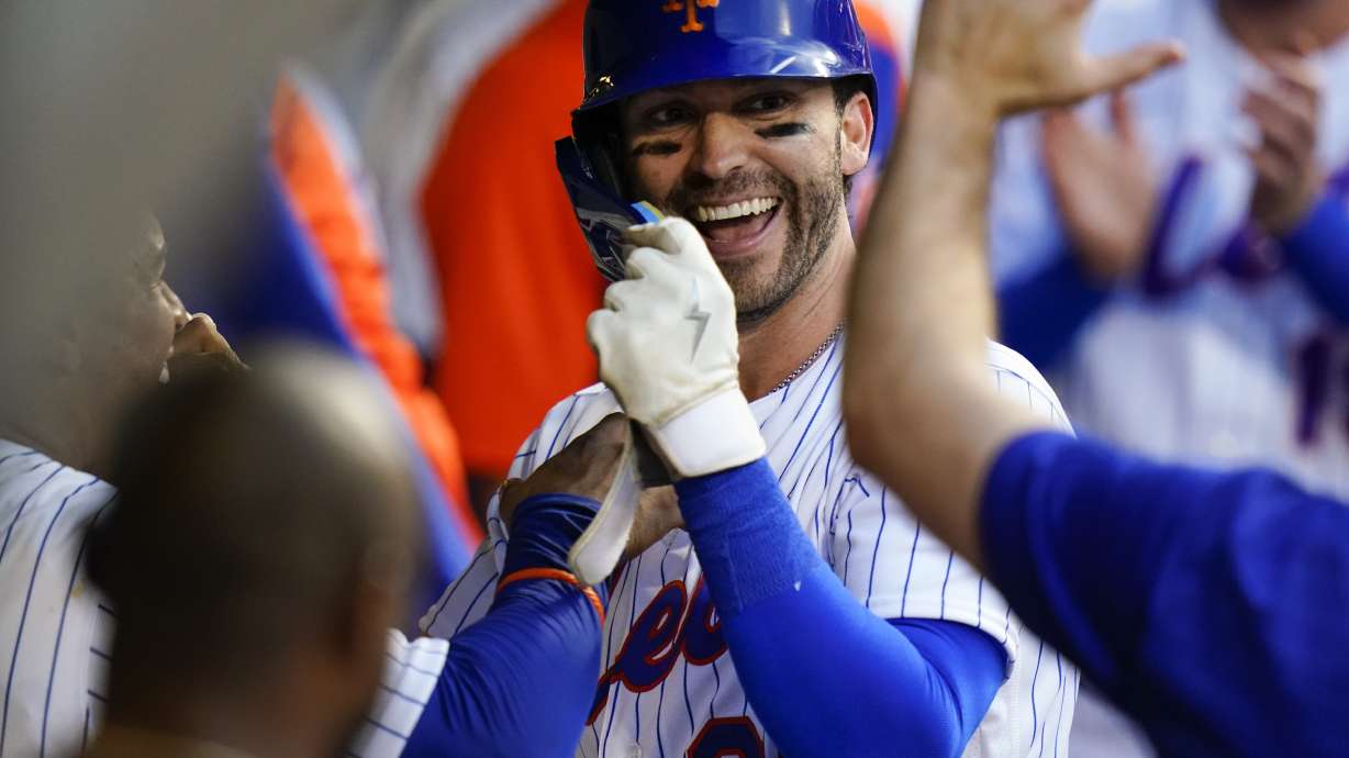 FILE - New York Mets' Tyler Naquin celebrates with teammates after hitting a home run during the second inning of the team's baseball game against the Atlanta Braves on Aug. 4, 2022, in New York.